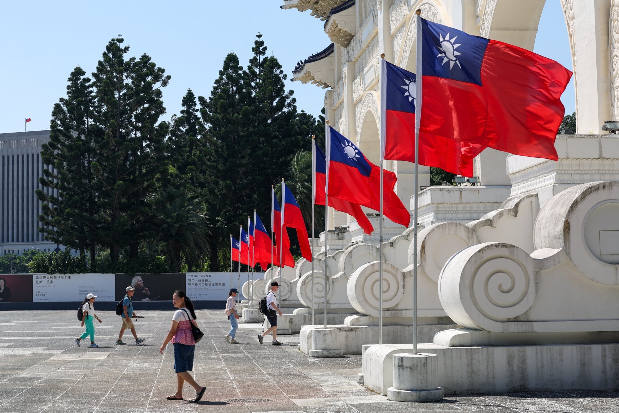 People walk past Taiwan flags outside Chiang Kai-shek Memorial Hall in Taipei on October 12. Photo: EPA