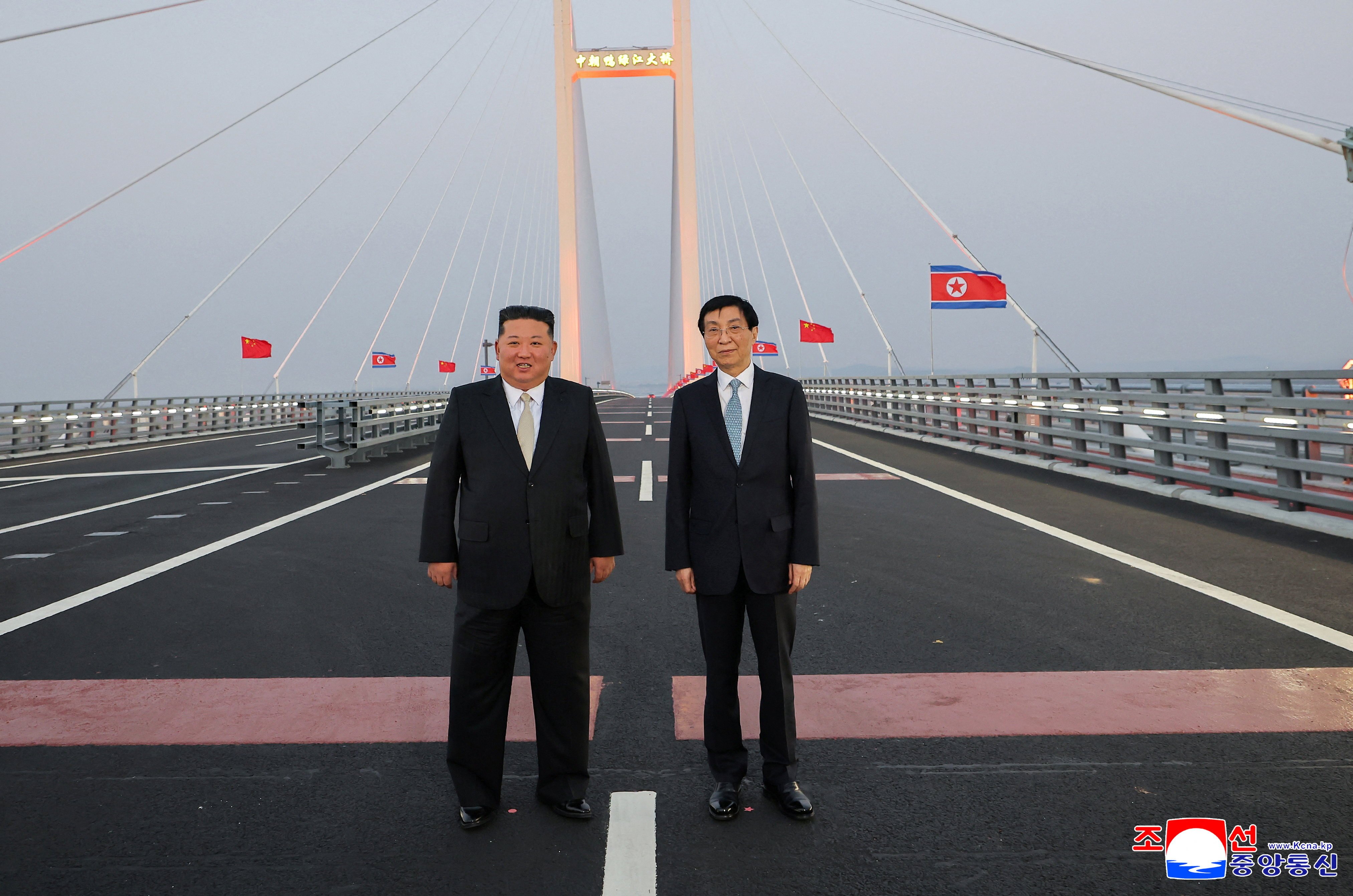 North Korean leader Kim Jong Un and Chinese People's Political Consultative Conference (CPPCC) Chairman Wang Huning pose for a photograph on the New Yalu River Bridge linking Dandong, China, and Sinuiju, North Korea, during Kim's visit to Dandong, Liaoning province, China, October 24, 2026, in this photo released by North Korea's Korean Central News Agency (KCNA). KCNA via REUTERS   ATTENTION EDITORS - THIS IMAGE WAS PROVIDED BY A THIRD PARTY. REUTERS IS UNABLE TO INDEPENDENTLY VERIFY THIS IMAGE. NO THIRD PARTY SALES. SOUTH KOREA OUT. NO COMMERCIAL OR EDITORIAL SALES IN SOUTH KOREA.