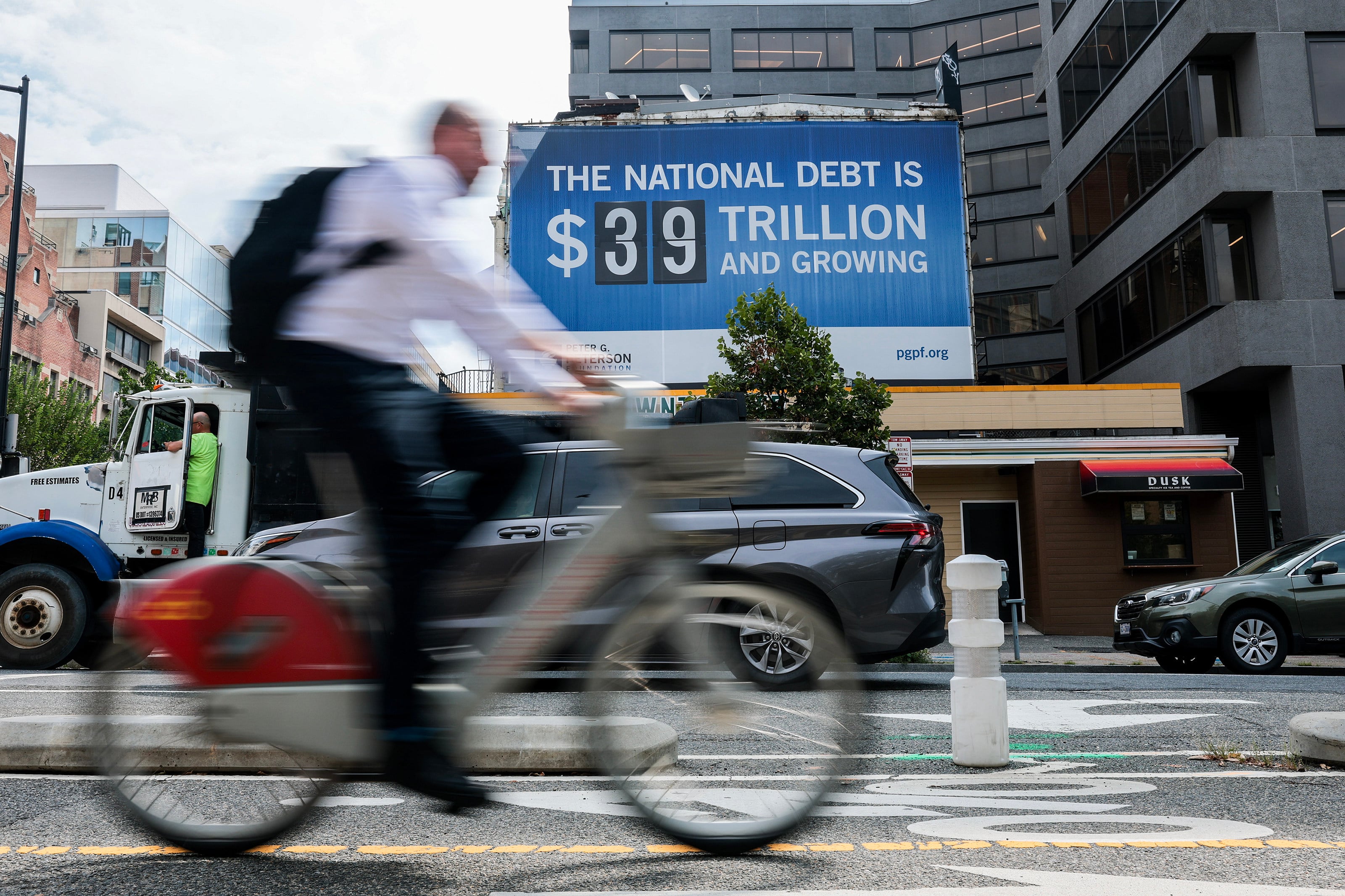 A sign displaying the US national debt hangs from a building in Foggy Bottom in Washington on August 20. Photo: Getty Images