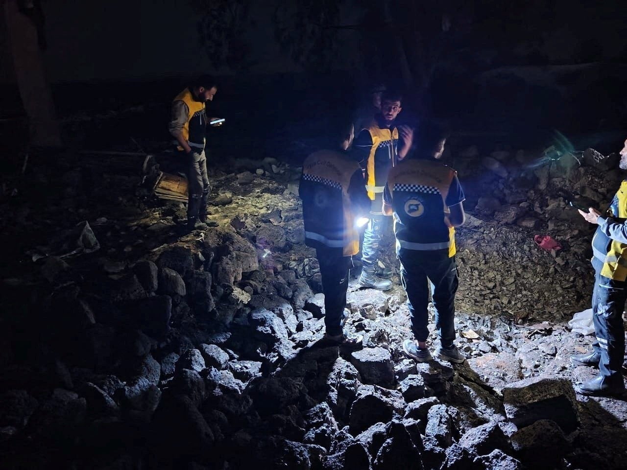 White Helmets rescue workers search through rubble following Jordanian airstrikes in southern Syria. Photo: White Helmets via Reuters