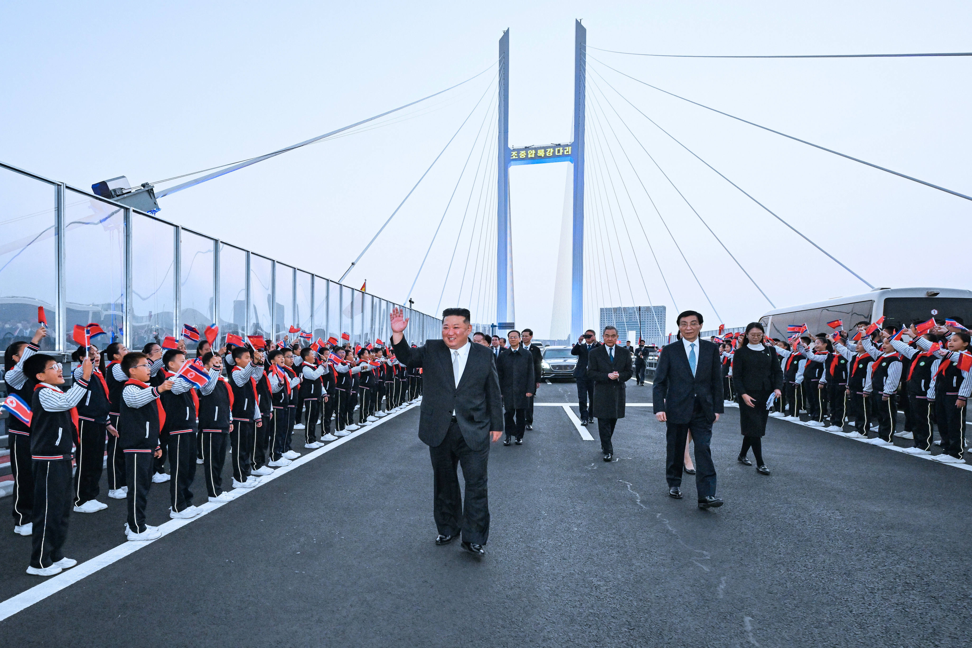 North Korean leader Kim Jong-un waves to attendees at a seeing-off ceremony on Saturday at the New Yalu River Bridge connecting China and North Korea. Photo: Xinhua via AP