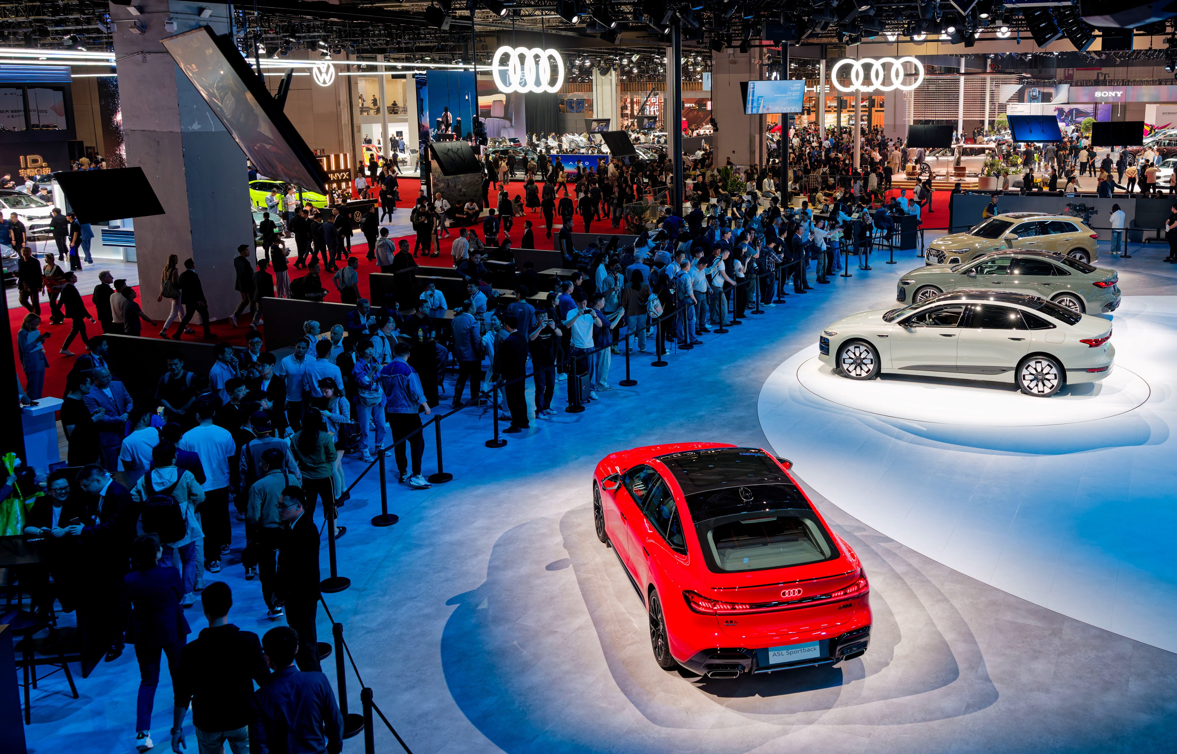 Visitors look at vehicles on display at the Audi booth during an expo in Shanghai last year. Photo: EPA-EFE