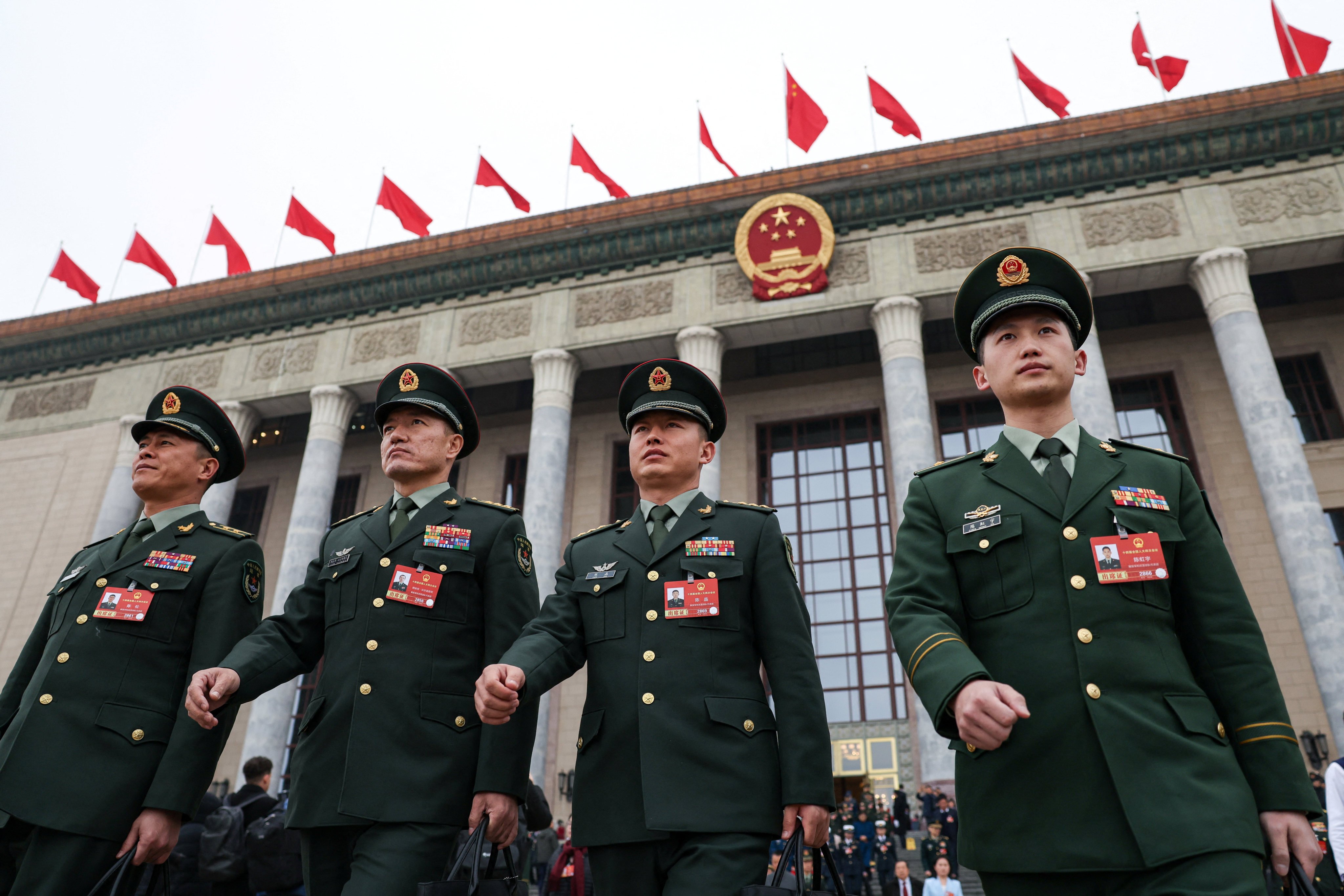 Members of the People’s Liberation Army walk outside the National People’s Congress at the Great Hall of the People in Beijing on March 5. Photo: Reuters