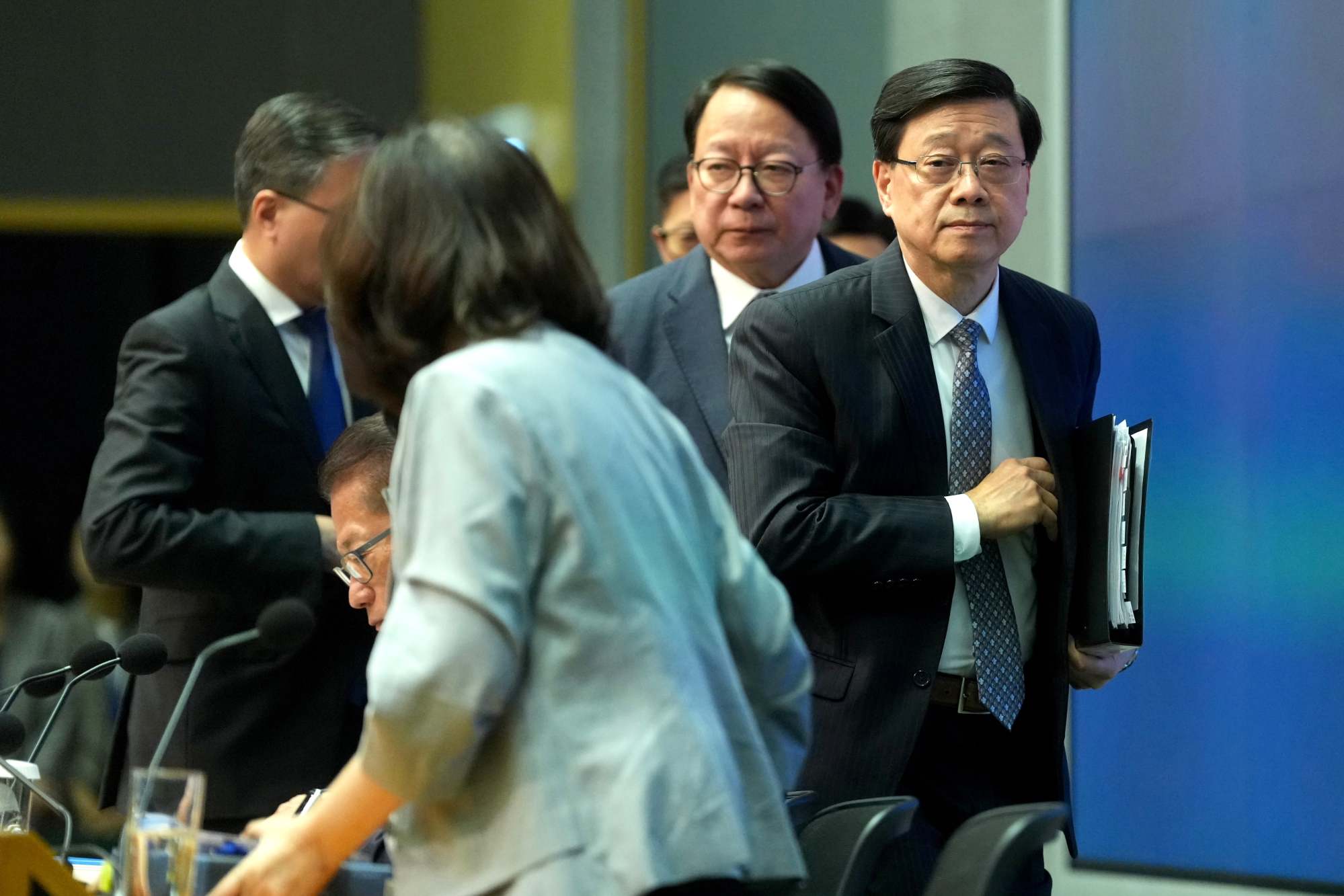 John Lee (right), Chief Secretary Eric Chan and their fellow officials depart after the briefing. Photo: Sam Tsang John Lee (right), Chief Secretary Eric Chan and their fellow officials depart after the briefing. Photo: Sam Tsang