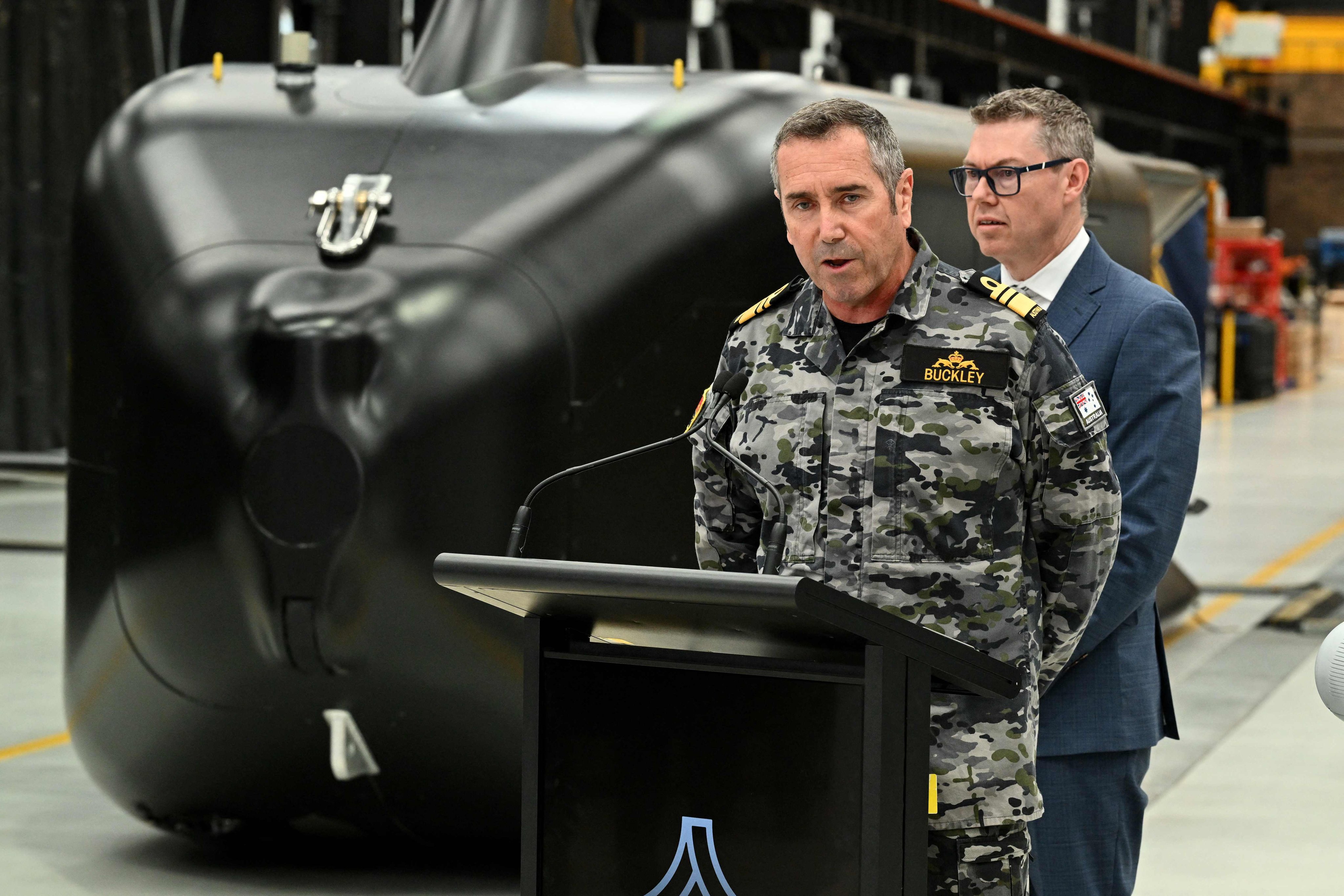 Royal Australian Navy Chief Vice-Admiral Matthew Buckley speaks to the media alongside Australias Minister for Defence Industry Pat Conroy in front of the Ghost Shark autonomous undersea vehicles in Sydney on October 19, during the unveiling of three new autonomous systems capabilities under AUKUS Pillar II. Photo: AFP