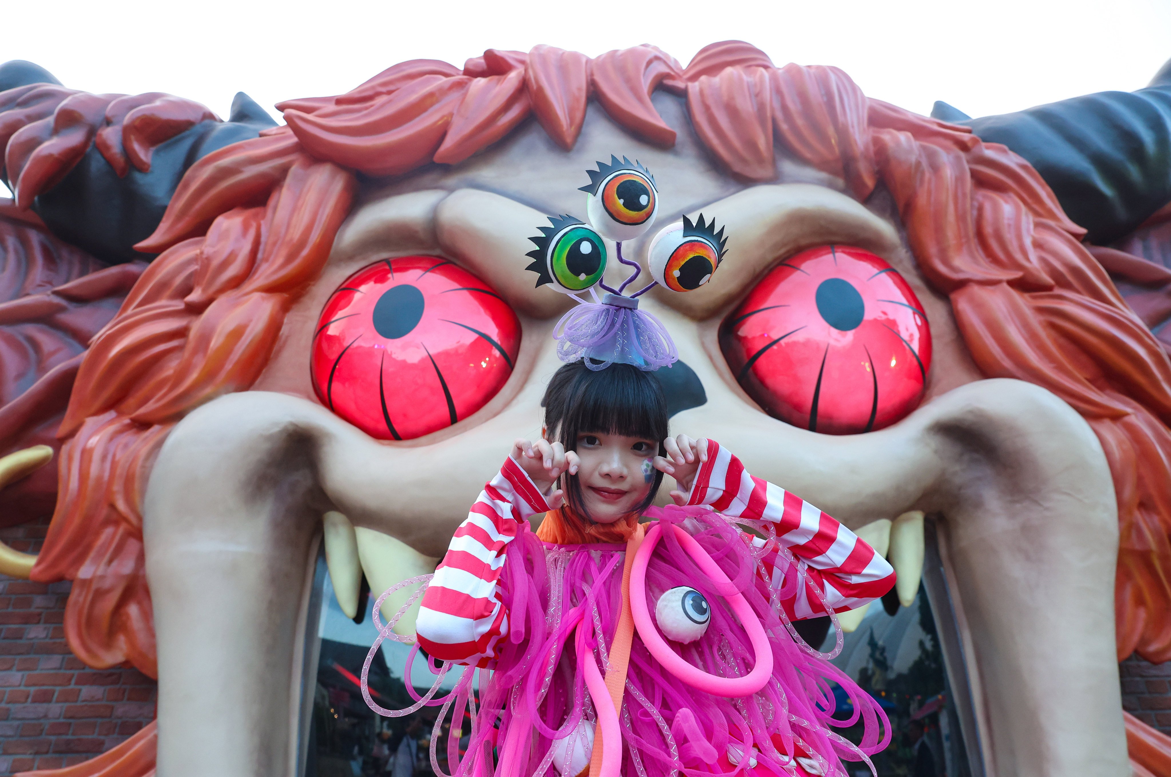 A girl in costume stands in front of The Grave Rave attraction at Ocean Park during a media preview on September 24, 2026. The attraction – part of Ocean Park's Halloween Fest 2026 – runs until November 1. Photo: Edmond So