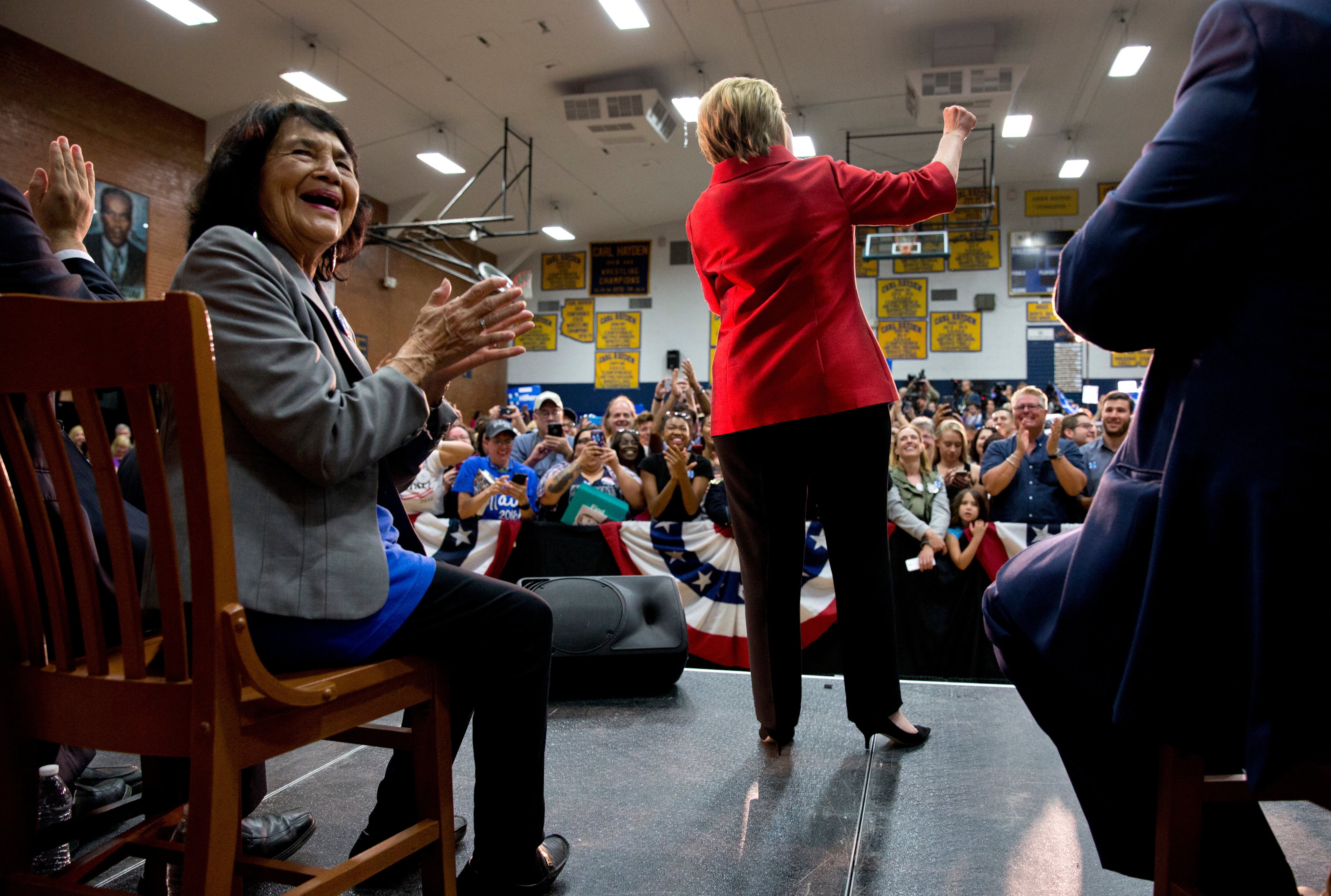 Dolores Huerta applauds on stage as Democratic presidential candidate Hillary Clinton speaks during a campaign event in 2016. Photo: AP