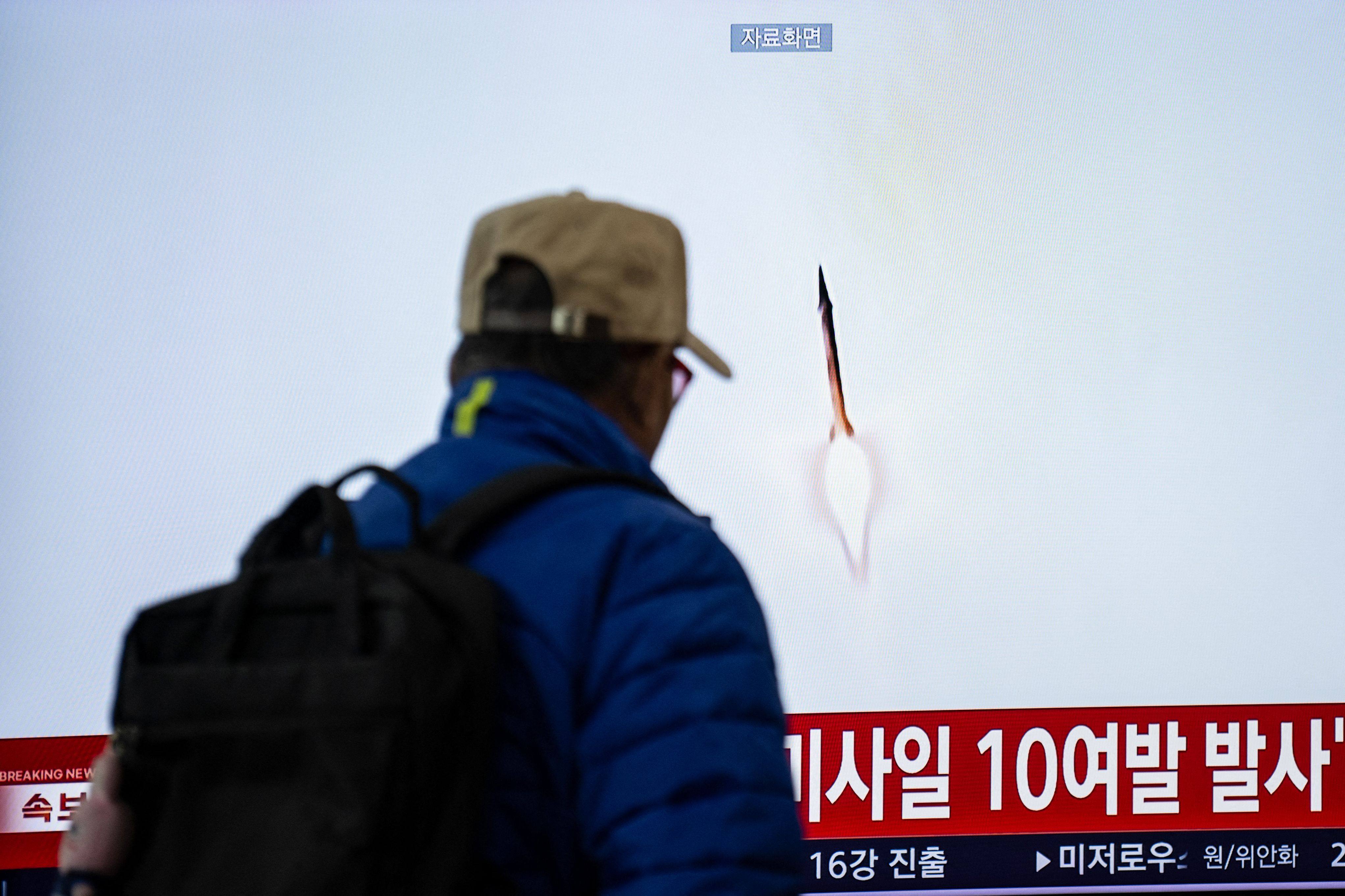 A man walks past a screen showing news coverage of a North Korean missile launch at Seoul Station on Thursday. Photo: AFP