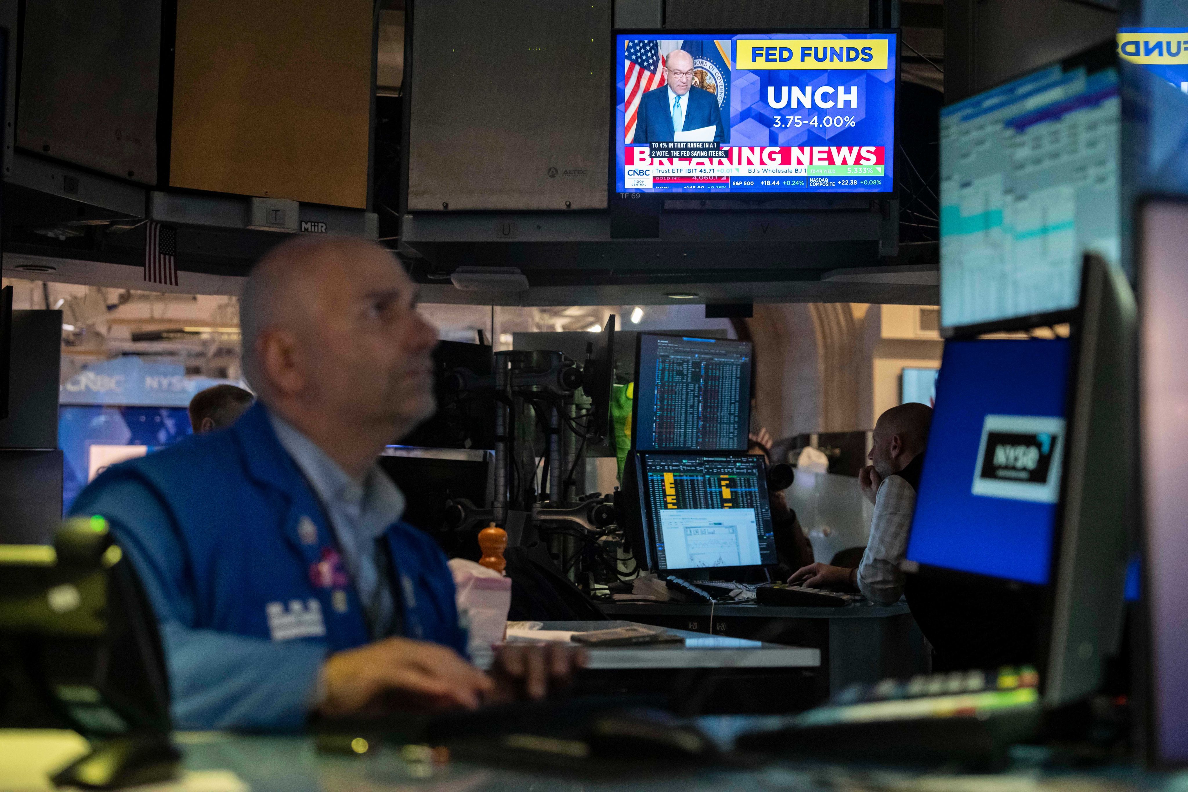 A  screen on the floor of the New York Stock Exchange displays the Federal Reserve rate decision on Wednesday. Photo: AP