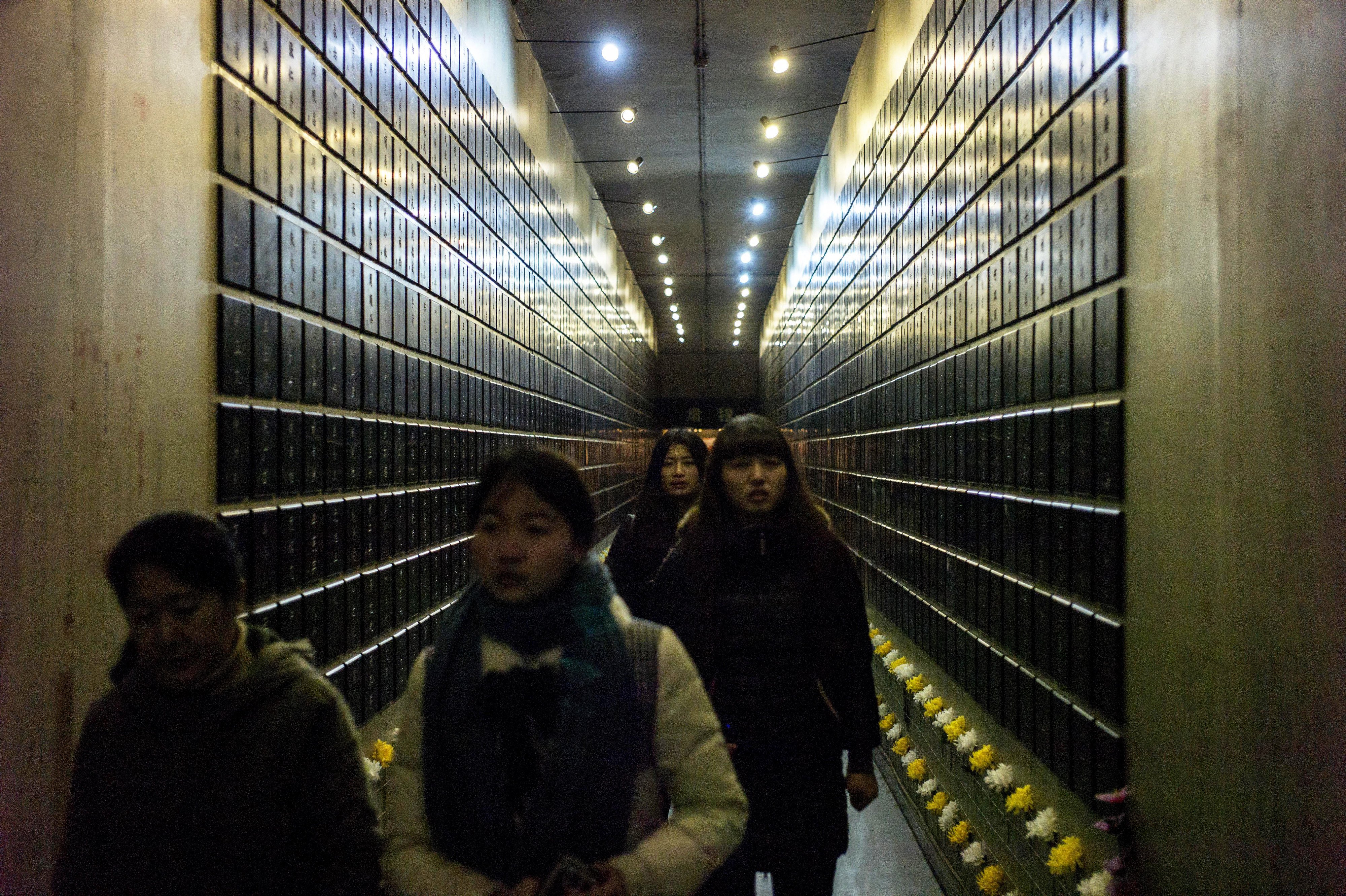 Visitors walk through a corridor listing the names of Unit 731's victims at a museum in Harbin, northeast China. An estimated 3,000 people died at the facility. Photo: AFP
