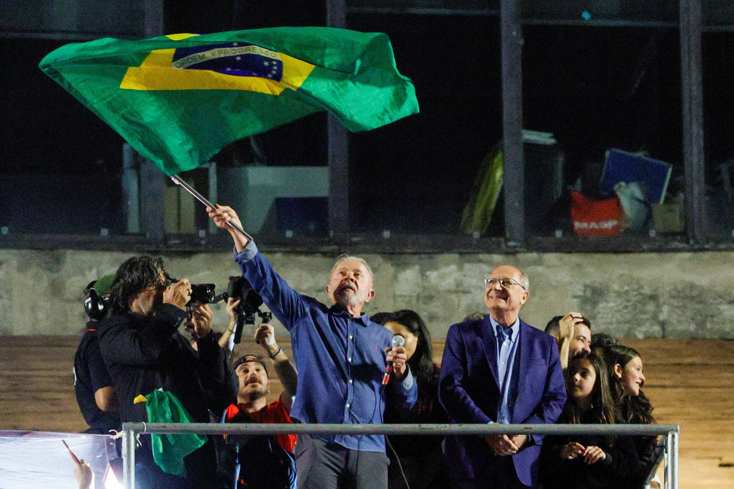 Brazil’s President Luiz Inacio Lula da Silva waves the national flag as he addresses supporters after his run-off victory, in Sao Paulo on October 26. Photo: Reuters