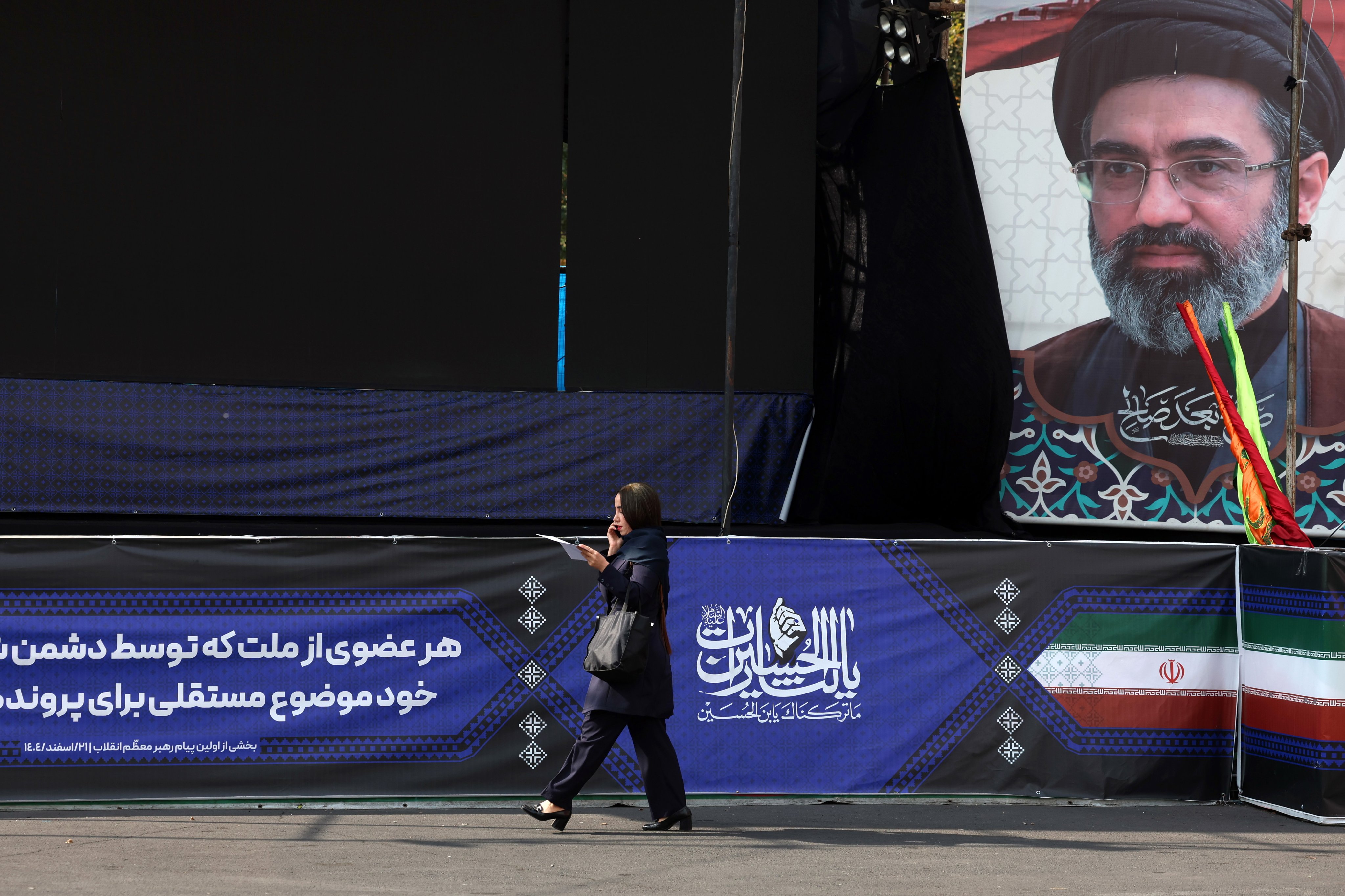 A woman walks past a billboard in Tehran showing Iranian Supreme Leader Mojtaba Khamenei. Photo: EPA