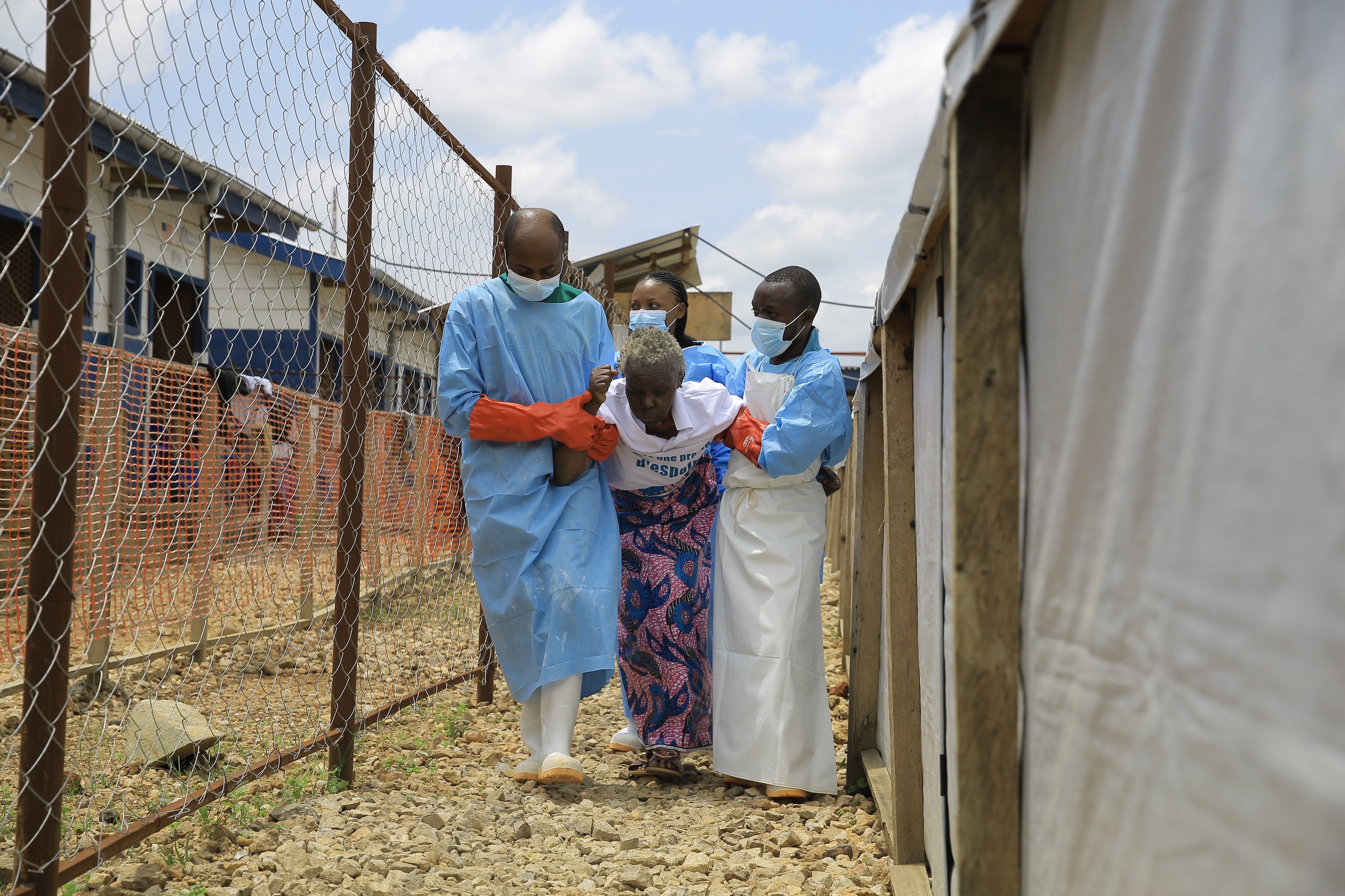 Healthcare workers help a patient on Tuesday after she was effectively treated for Ebola in eastern Congo’s North Kivu province. Photo: AP