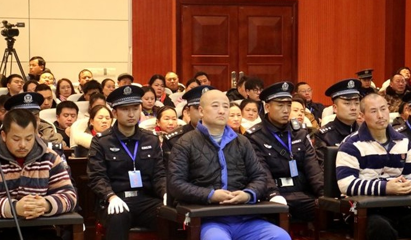 A court in Hunan province jails Zhang Tianming (centre), the founder of the Shanxinhui pyramid scheme, for 17 years. Photo: CCTV