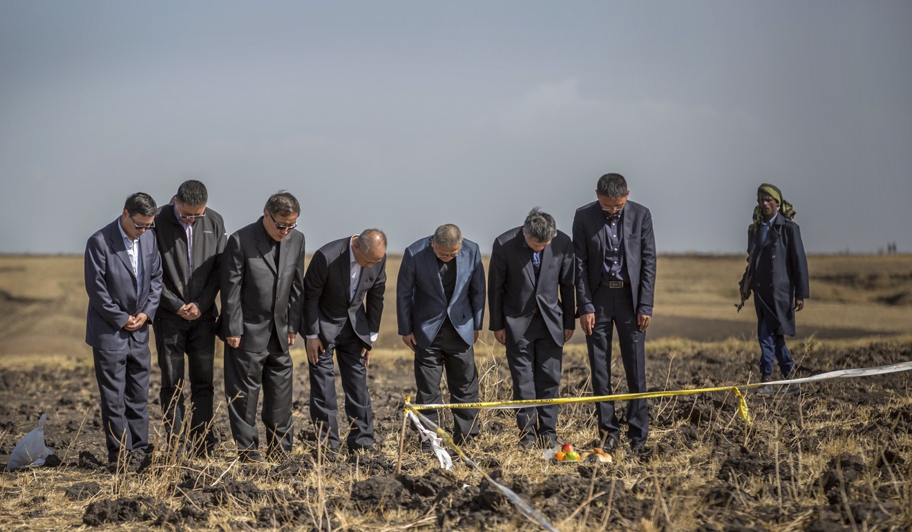 Officials from the Aviation Industry Corporation of China (AVIC) pray at the scene where the Ethiopian Airlines Boeing 737 MAX 8 crashed. Photo: AP