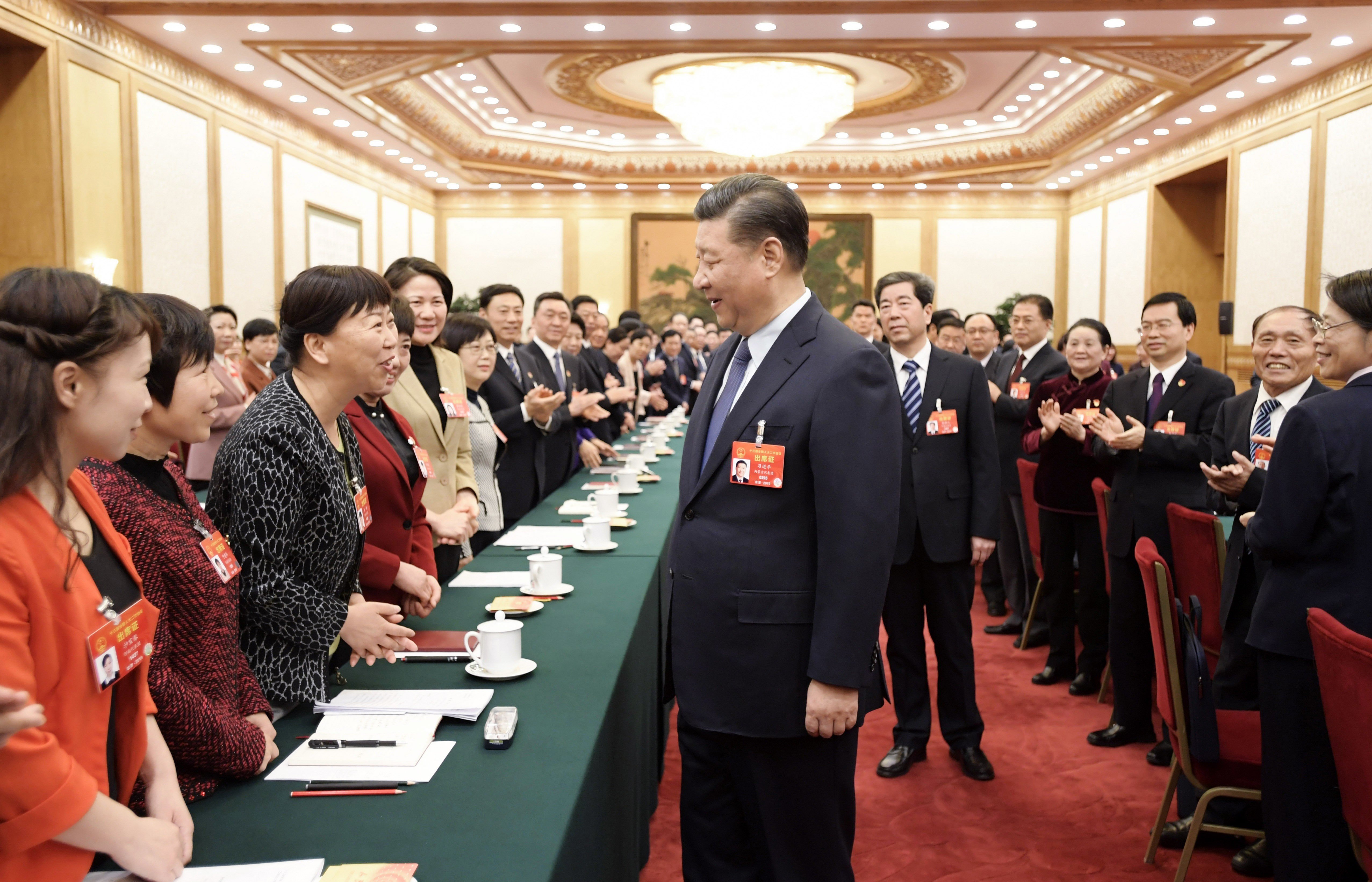 President Xi Jinping stops to talk to National People’s Congress deputies during a session of the annual meeting on March 8, in Beijing. Xi is determined that China must continue to champion globalisation. Photo: Xinhua
