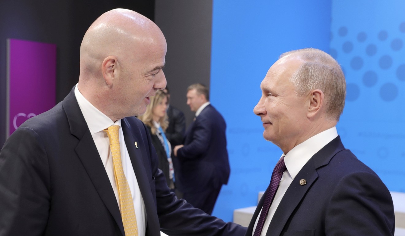 Infantino, left, speaks to Russian President Vladimir Putin at the G20 summit. Photo: AP
