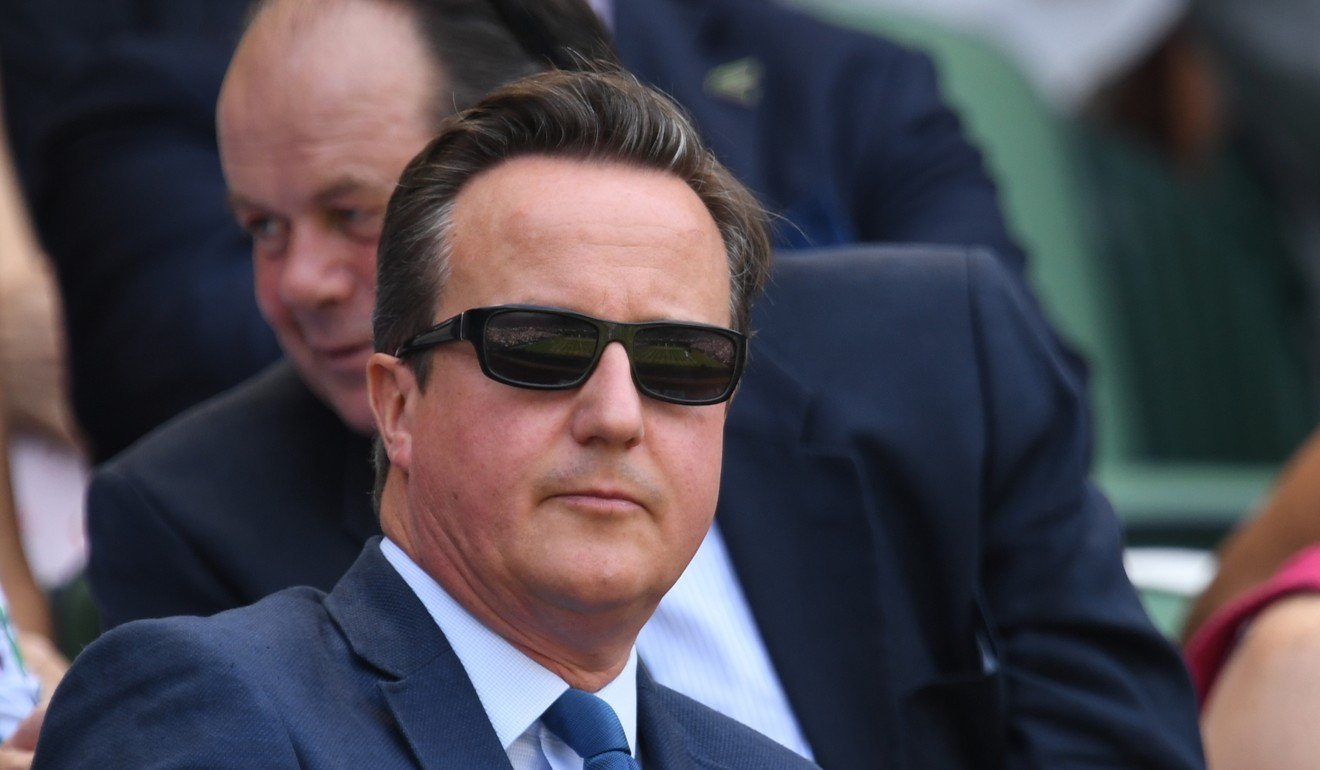 Former UK prime minister David Cameron enjoys watching a game of tennis at Wimbledon. Photo: AFP