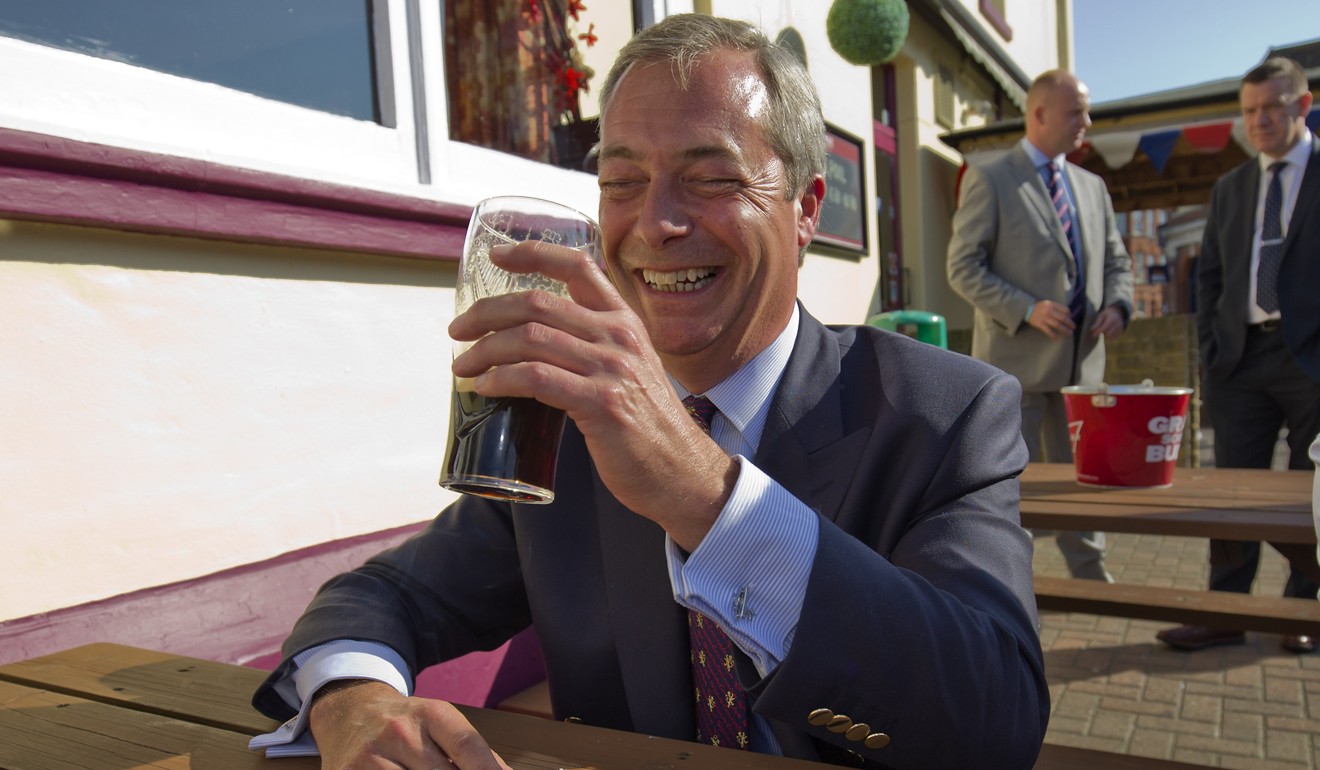 Nigel Farage enjoys a cigarette and a beer. File photo: AFP
