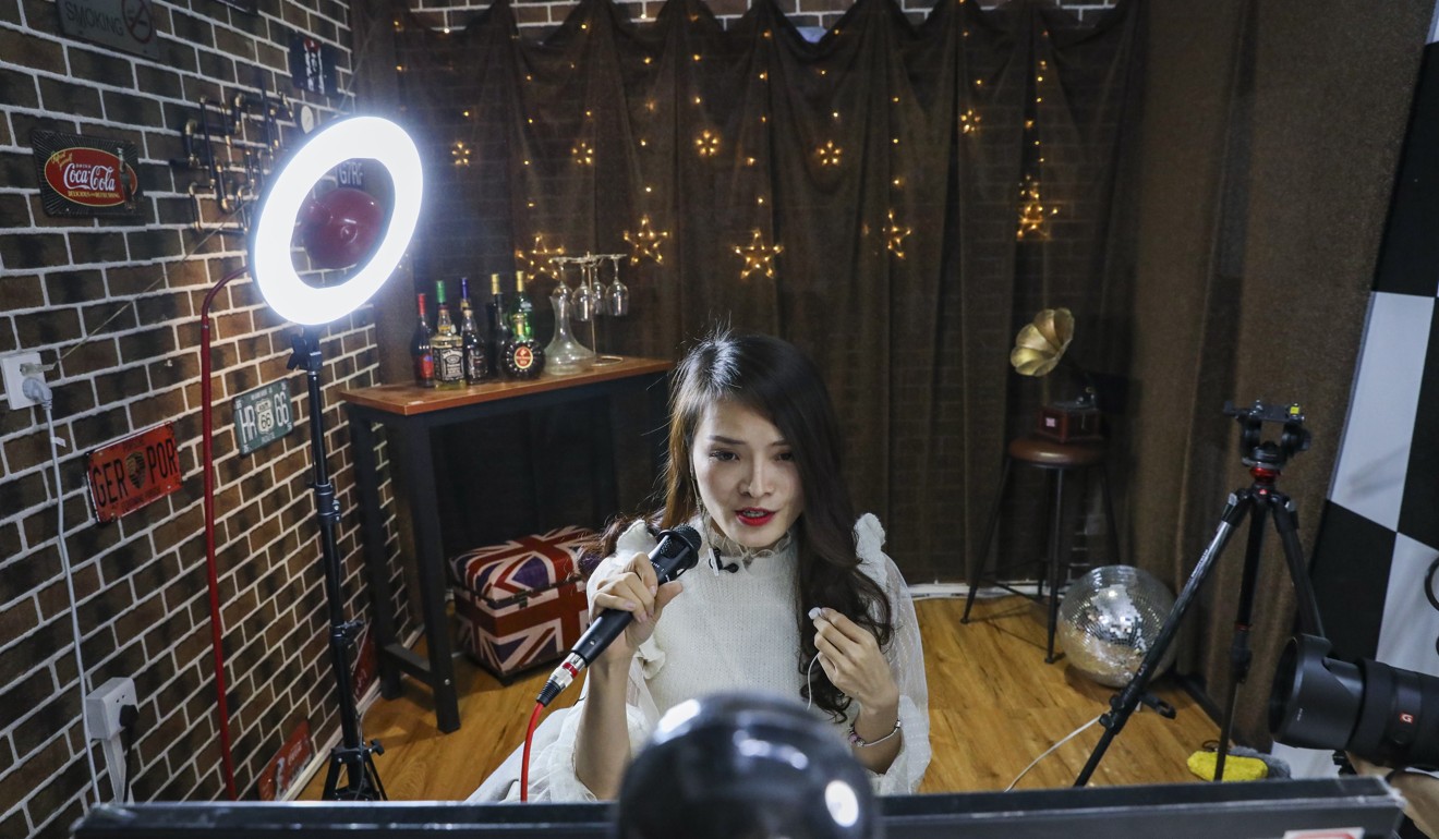 Yoyo Jiang, 27, singer and chat host, performs live for her online fans. KOLs hired by Hifan multi-channel network in Guangzhou, China, broadcast online in the Company’s compartment offices. 20DEC18 SCMP / Nora Tam