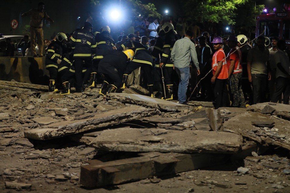 Fire brigade officers clear debris after a footbridge collapsed outside the Chhatrapati Shivaji Terminus railway station in Mumbai. Photo: Xinhua
