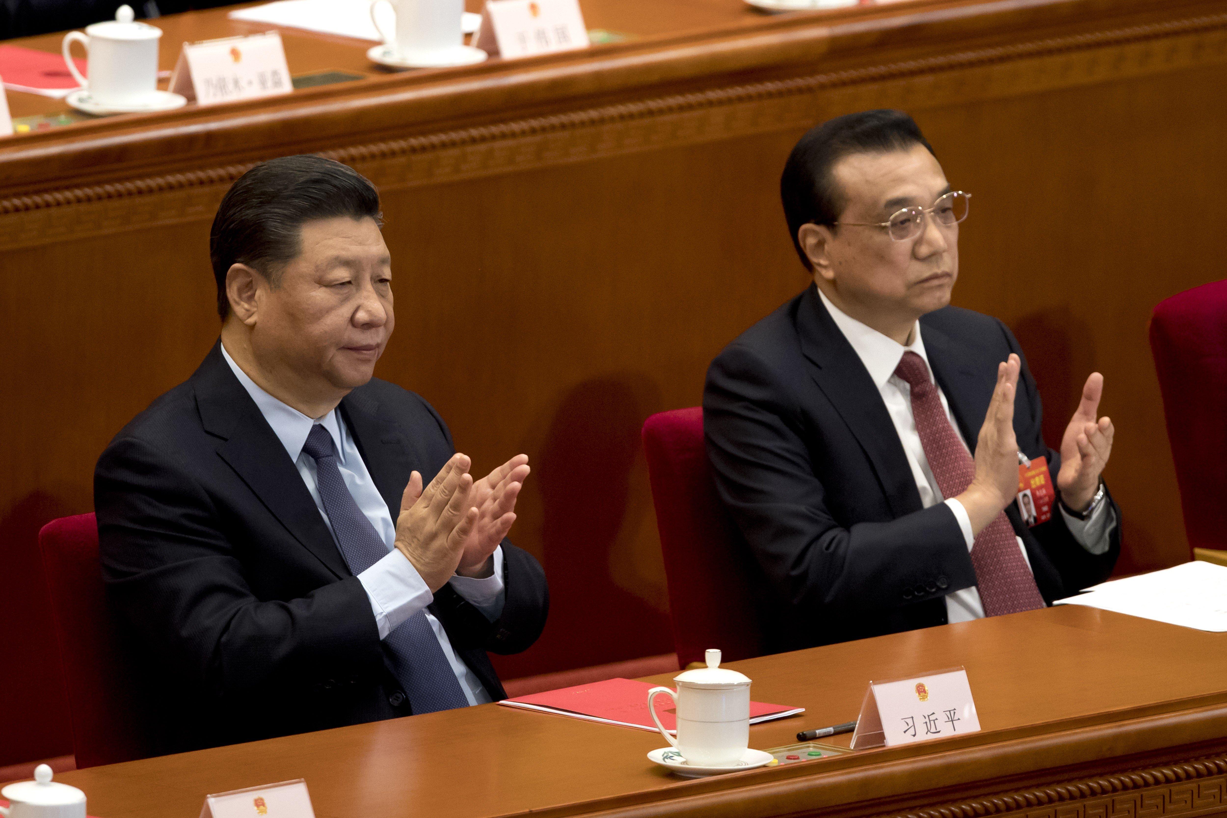 Chinese President Xi Jinping (left) and Premier Li Keqiang applaud during the closing session of the National People’s Congress in Beijing on Friday. Photo: AP