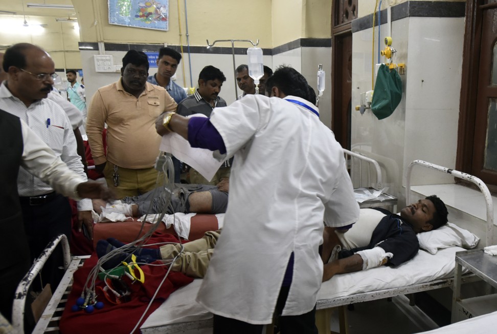 Doctors treat a man who was injured in a pedestrian bridge collapse in Mumbai, India, on Thursday. Photo: AP