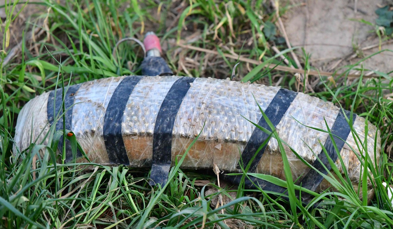 This picture taken on March 15, 2019 shows a discarded explosive belt in the grass at the remains of an Islamic State jihadists' camp near the village of Baghouz. Photo: AFP/Giuseppe Cacace