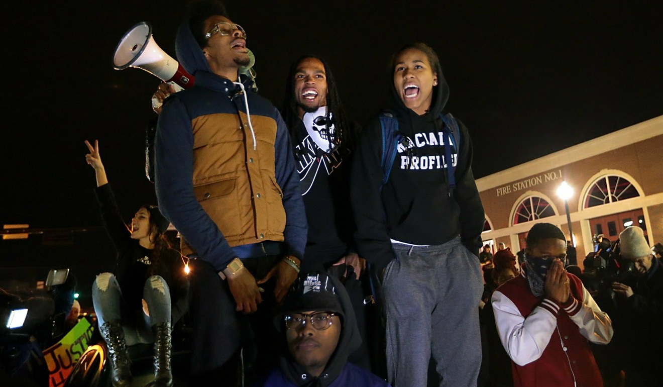 Ferguson activist Daren Seals, top centre, awaits the decision by a grand jury on whether to indict Darren Wilson in the death of Michael Brown. Photo: St. Louis Post-Dispatch via AP