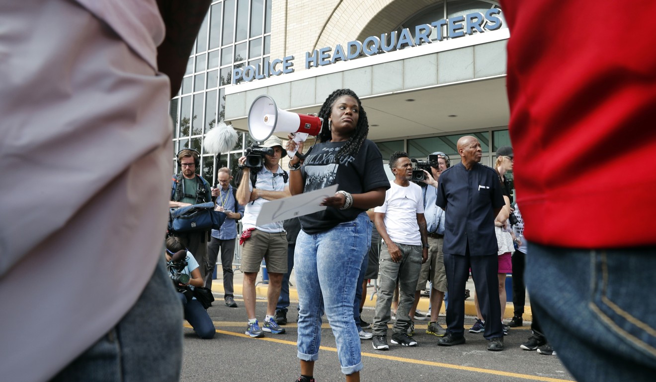 Cori Bush speaks on a bullhorn to protesters outside the St. Louis Police Department headquarters. Photo: AP Photo