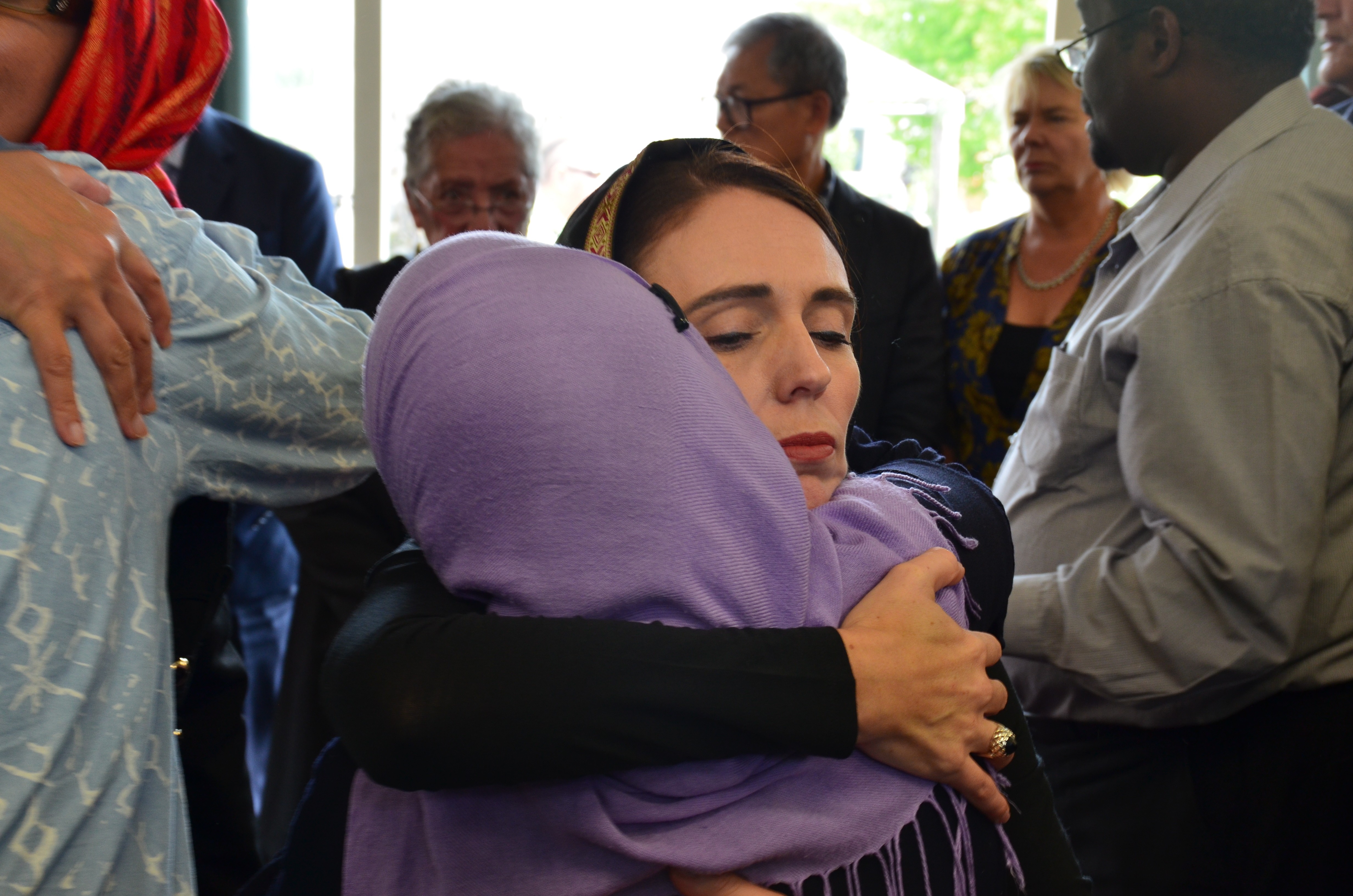 New Zealand Prime Minister Jacinda Ardern (C) with members of the Muslim community in Christchurch. Photo: EPA-EFE