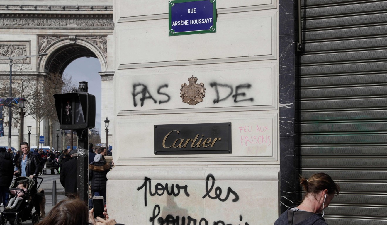 Graffiti on the facade of a Cartier store reads: ‘No mercy for bourgeois’. Photo: AFP