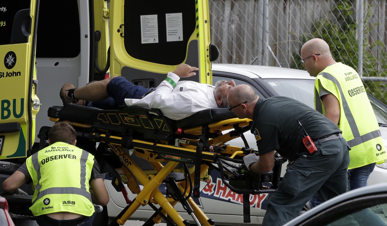 Ambulance staff take a man from outside the mosque. Photo: AP
