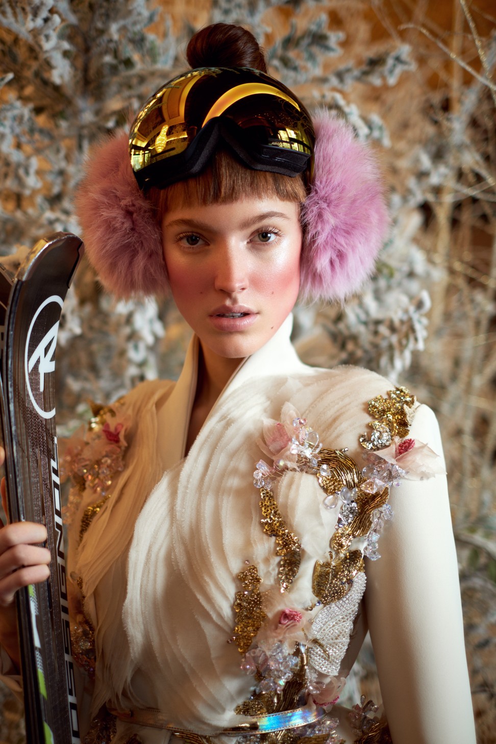 Elie Saab Haute Couture jasmine double crepe suit with wide flair leg trousers; jacket adorned with organza ruffles sequins, crystals and multiple beaded flowers; Peauluxe earmuffs; Rossignol skis; stylist’s own ski goggles