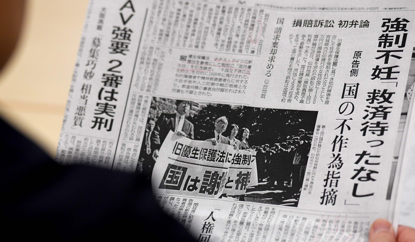 Michiko Sato, sister-in-law of Yumi Sato, who was sterilised as a teenager, reads a newspaper. Photo: AFP