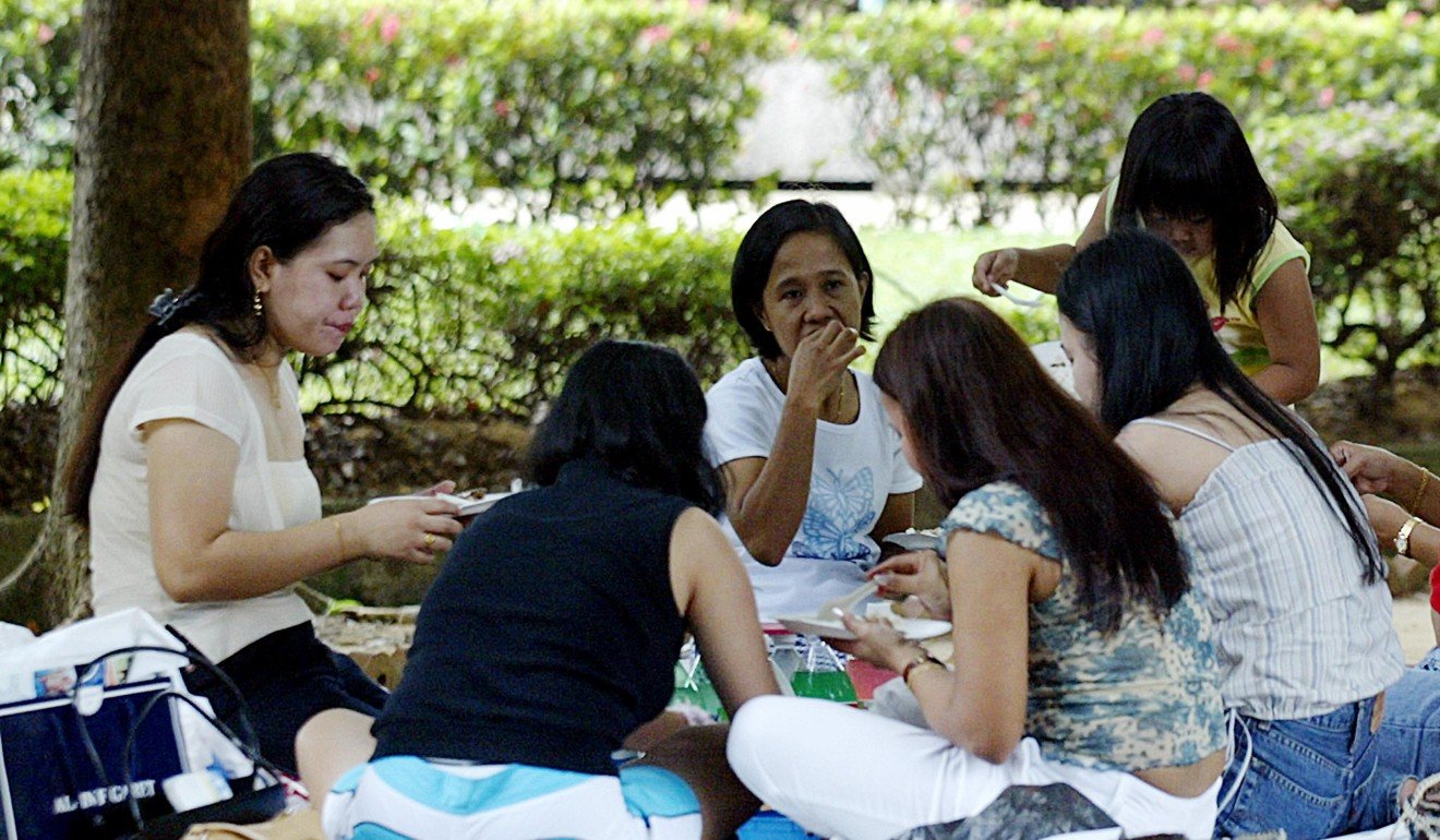 Domestic workers at a park in Singapore. Photo: AFP