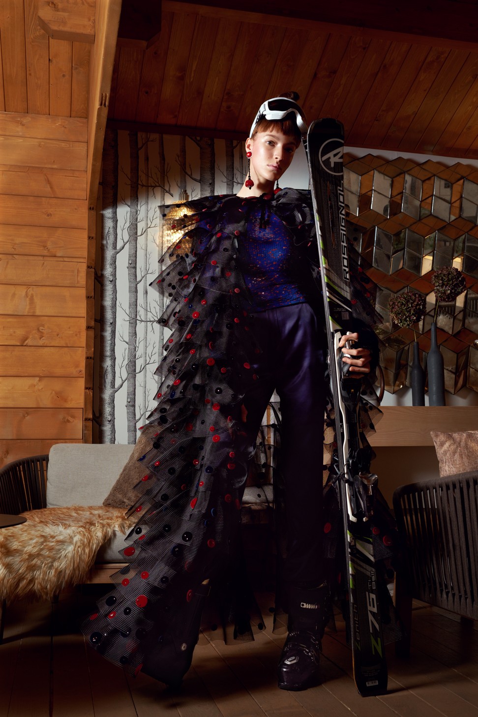 Giorgio Armani crinoline cape embroidered with point d'esprit effect crystals; top embroidered all over with sequins; royal blue silk satin pants; Rossignol skis; Salomon ski boots; stylist’s own ski goggles