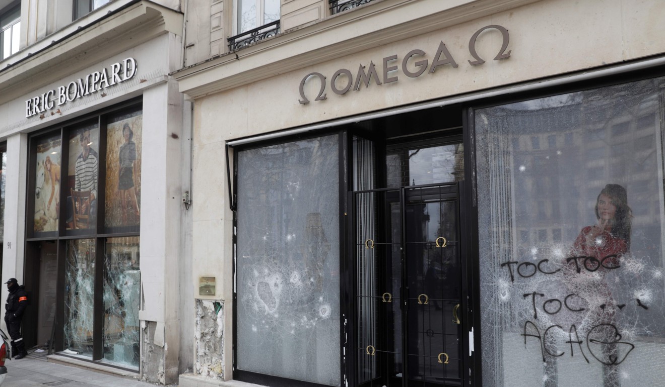 Damaged windows of shops on the Champs-Elysees avenue in Paris. Photo: AFP