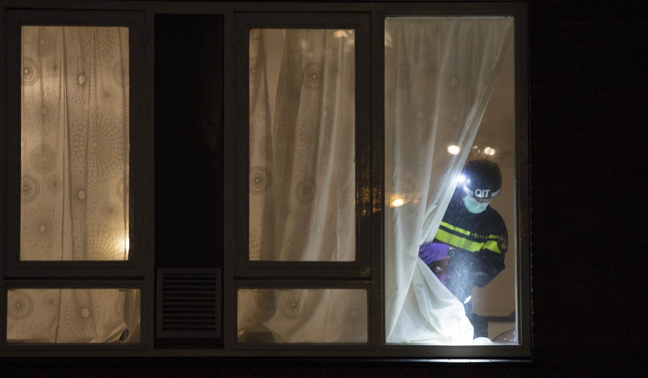A forensic expert looks for clues in a house where the suspect of a shooting incident was arrested in Utrecht, Netherlands, on Monday. Photo: AP