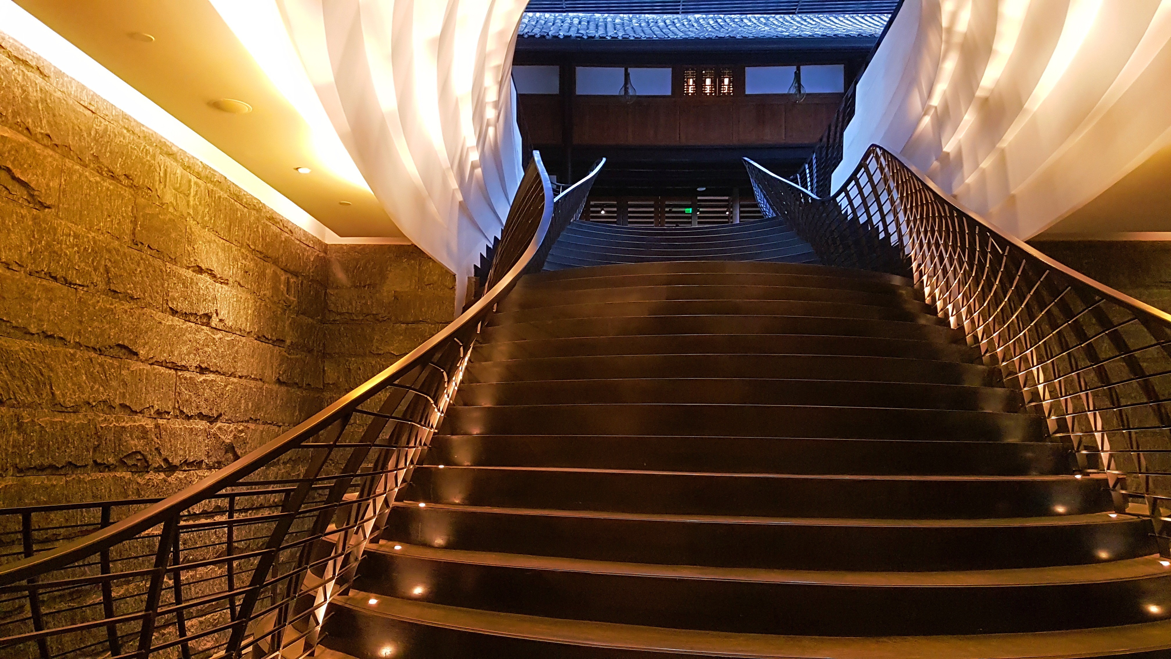A sweeping staircase at Chengdu’s The Temple House, a hotel which blends traditional and modern design.