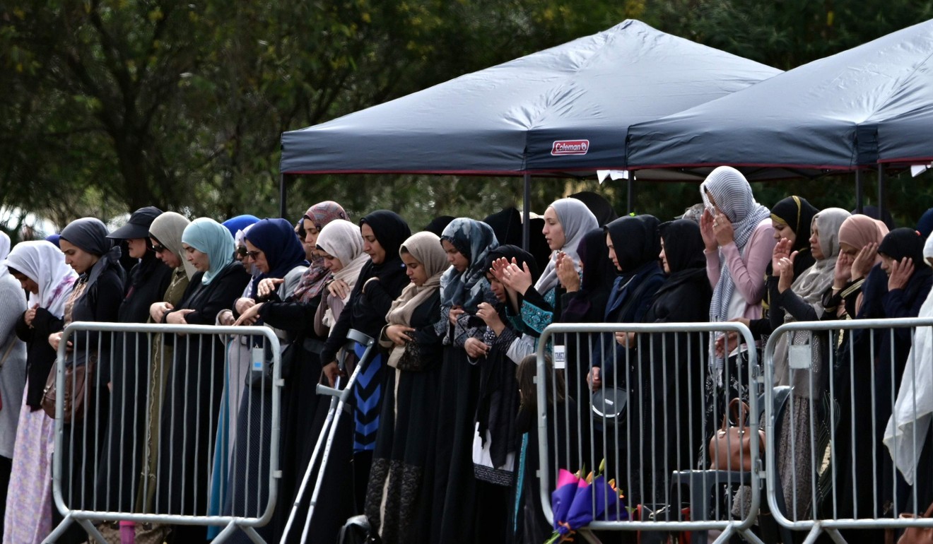 Mourners offer prayers for Khalid Mustafa and his son Hamza. Photo: AFP