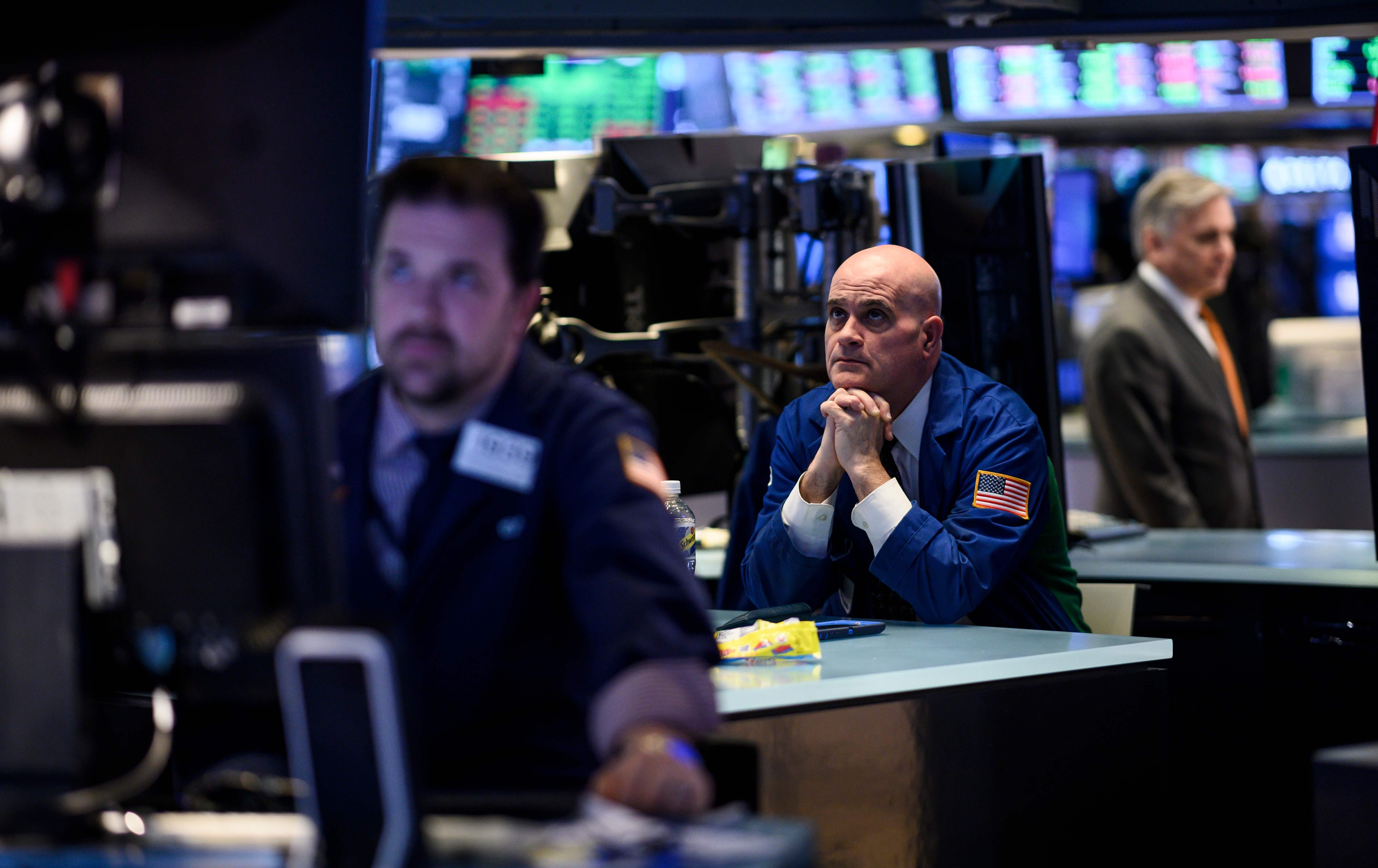 Traders work ahead of the closing bell on the floor of the New York Stock Exchange on March 18, on a day when stocks finished higher thanks to gains from petroleum companies and banks. Photo: AFP