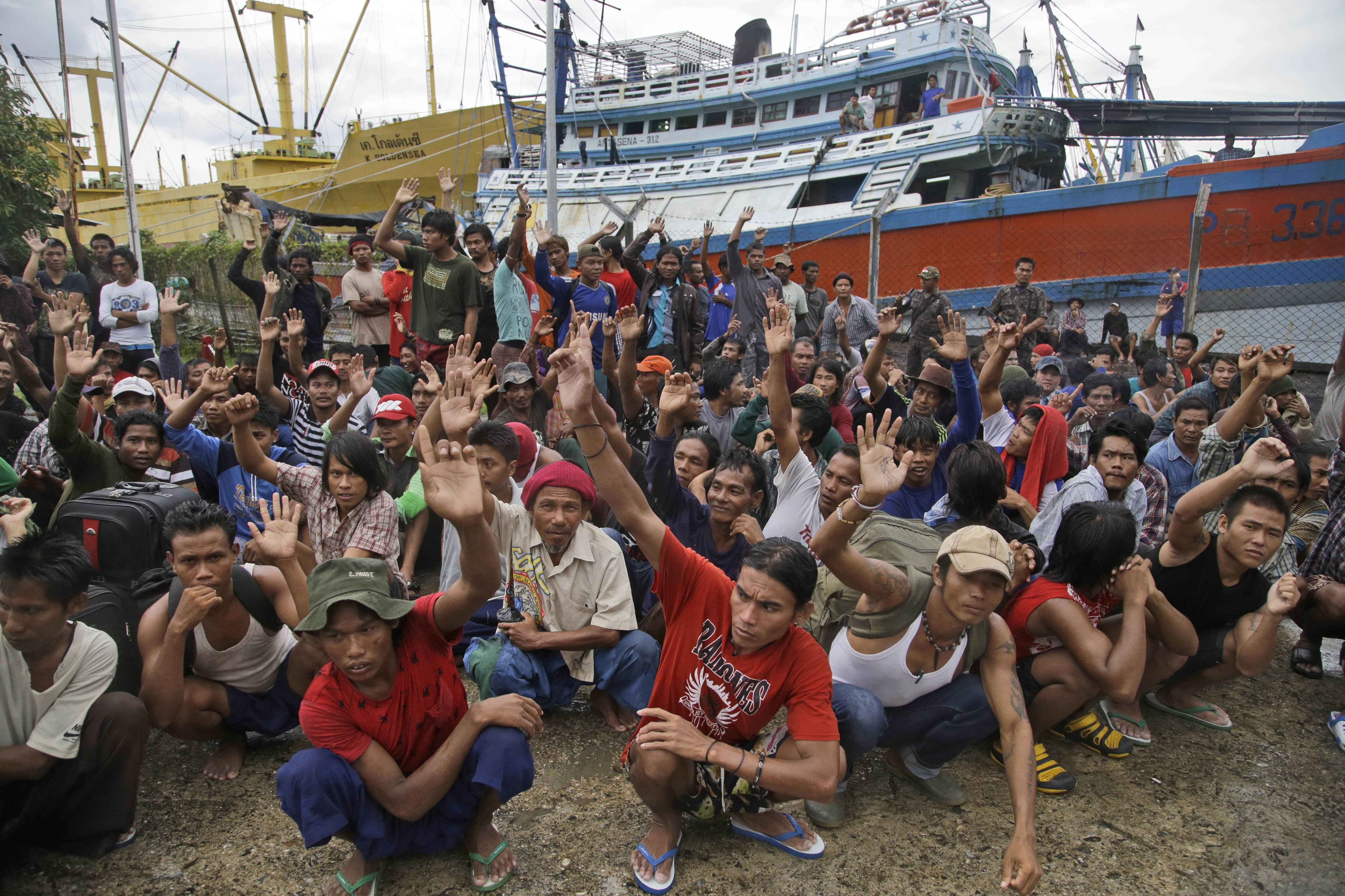 Burmese fishermen raise their hands when they are asked who wants to go home, following a report on rampant slavery in the fishing industry in the remote Indonesian island village of Benjina. Photo: AP