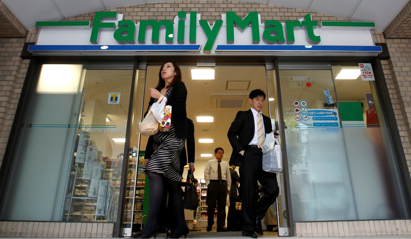 Customers walk out of a FamilyMart convenience store in Tokyo. Photo: Reuters