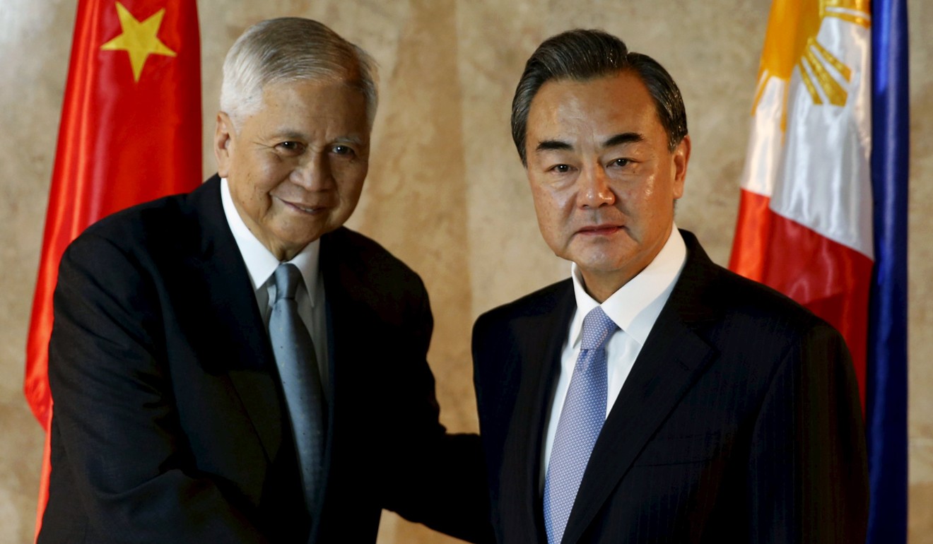 Albert del Rosario with Chinese Foreign Minister Wang Yi, who was named as a ‘perpetrator’ in the complaint. Photo: Reuters