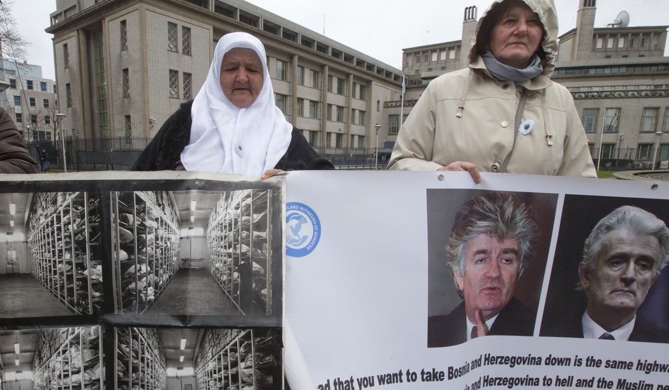 Mothers of Srebrenica hold images of bodies exhumed from mass graves and of Karadzic outside the court building. Photo: AP