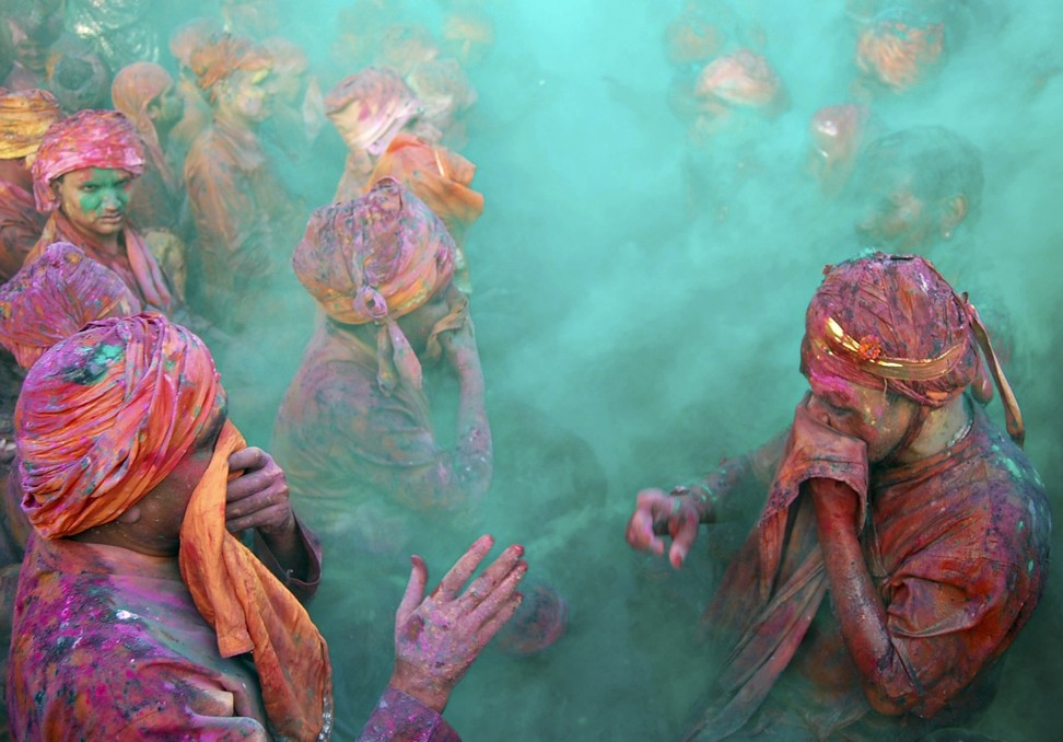 People throwing coloured powder during Holi at Nand Gaon in Uttar Pradesh. Photo: Reuters