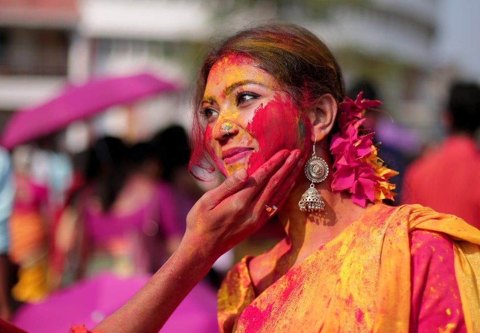 Indian students rubbing paint on each other as they celebrate Holi at Tagore University in Kolkata, eastern India. Photo: EPA-EFE