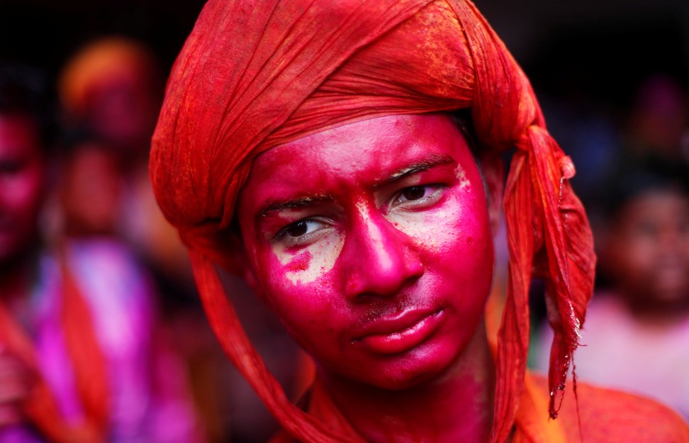 Red, one of the four main powder colours used during Holi, represents love and fertility. Photo: Reuters
