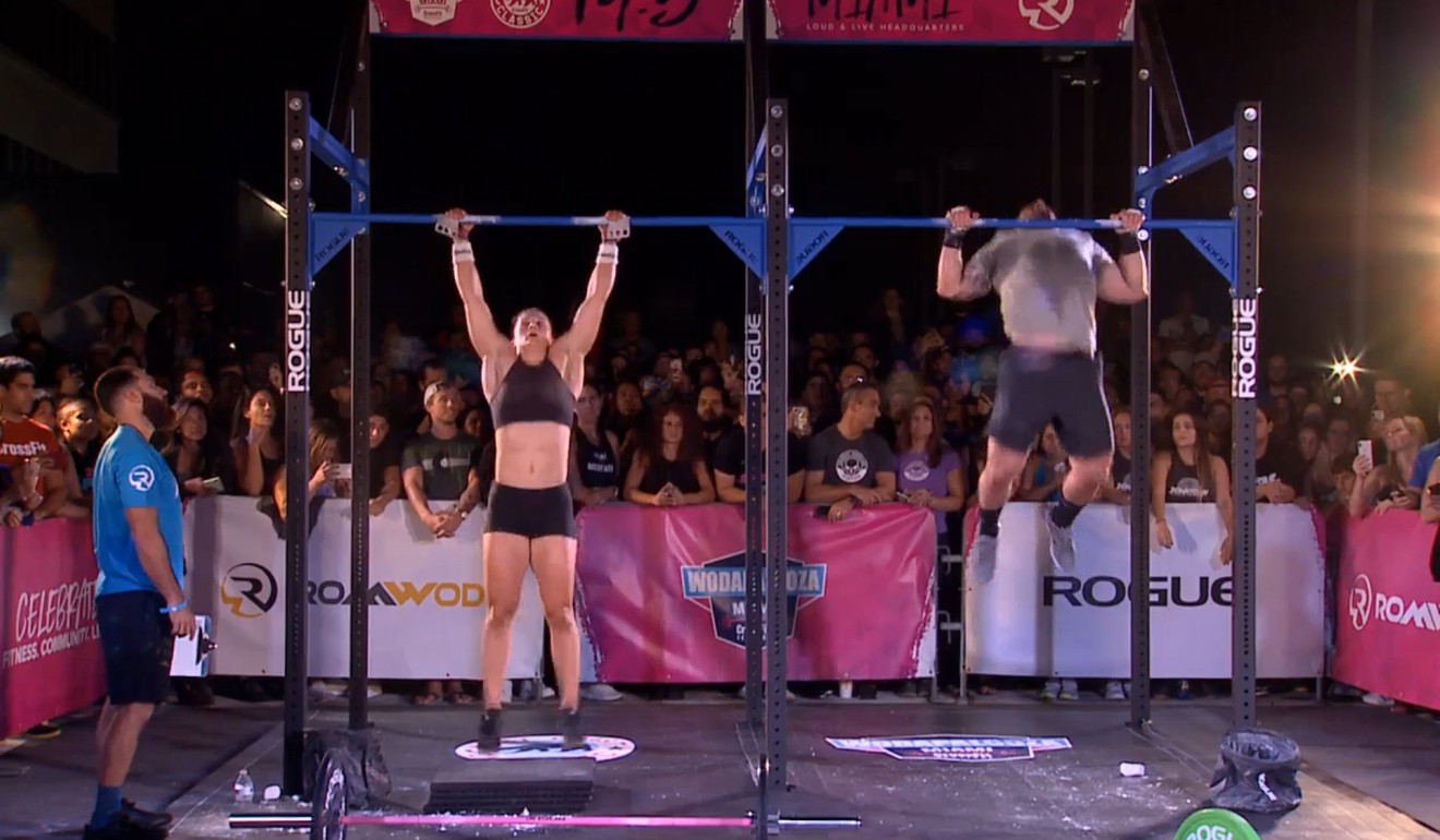 Tia-Clair Toomey and Mat Fraser do chest-to-bar pull-ups in 19.5.